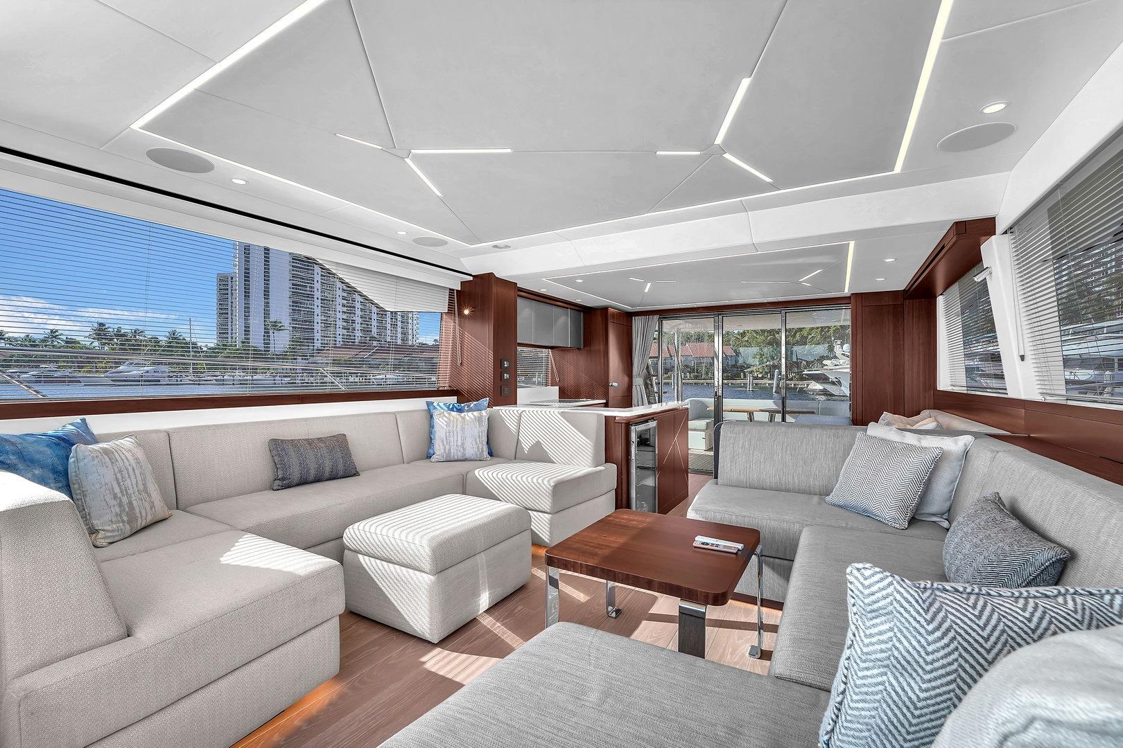 Luxurious interior of 2023 Sunseeker Manhattan 68 yacht with modern seating and panoramic windows.