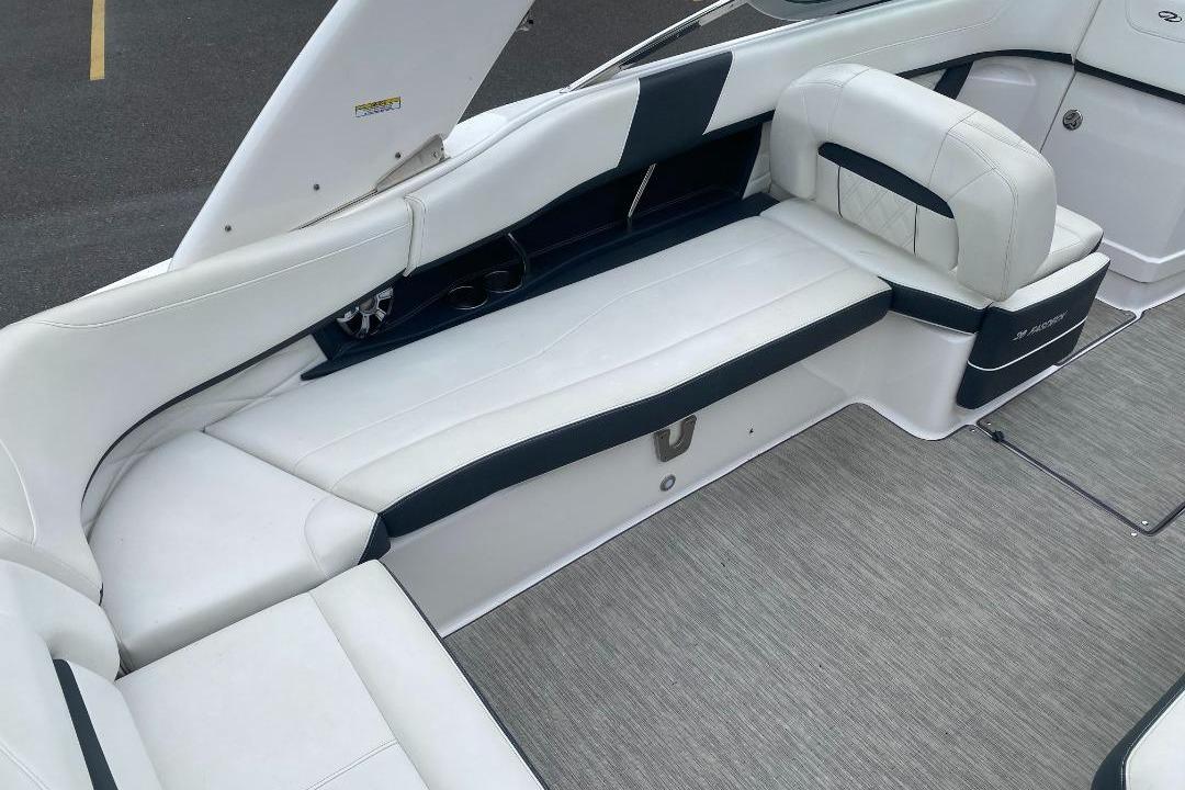 Interior seating of a 2018 Regal 26 FasDeck boat, featuring white and black upholstery.