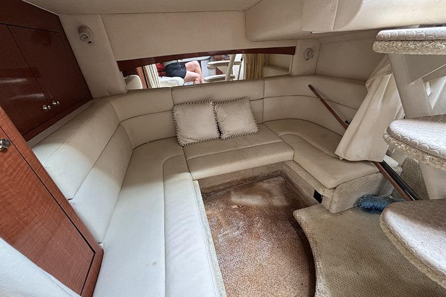 Interior of a 2002 Sea Ray Sundancer 320 yacht with plush seating and carpeted flooring.