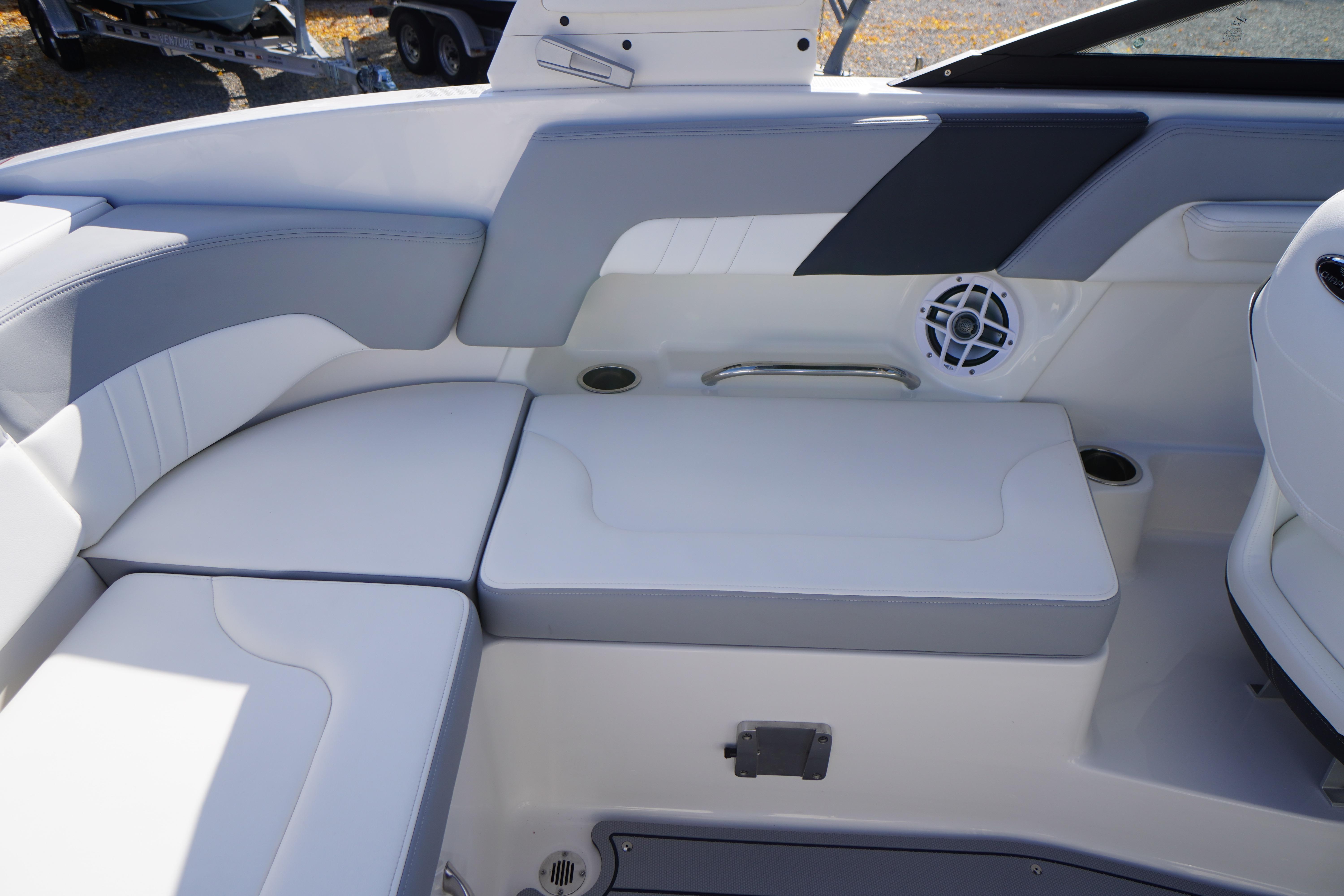 2026 Chaparral 23 SSi OB boat interior with cushioned seating and speaker system.