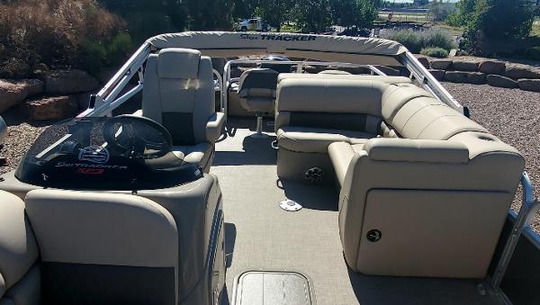 2023 Sun Tracker SportFish 22 XP3 pontoon boat interior with beige seating.