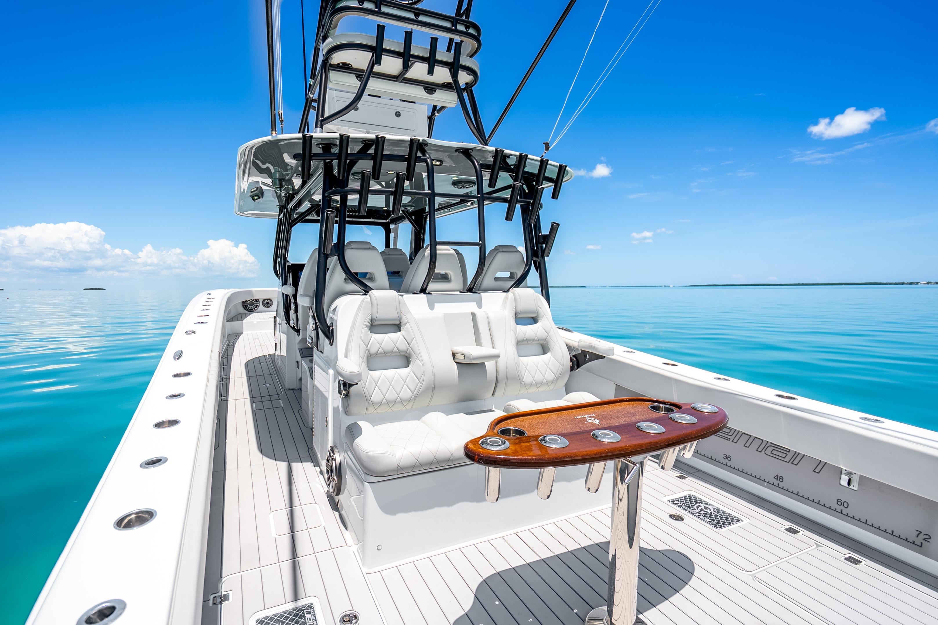 2024 Freeman 42 boat interior with luxurious seating and fishing rod holders on calm blue water.