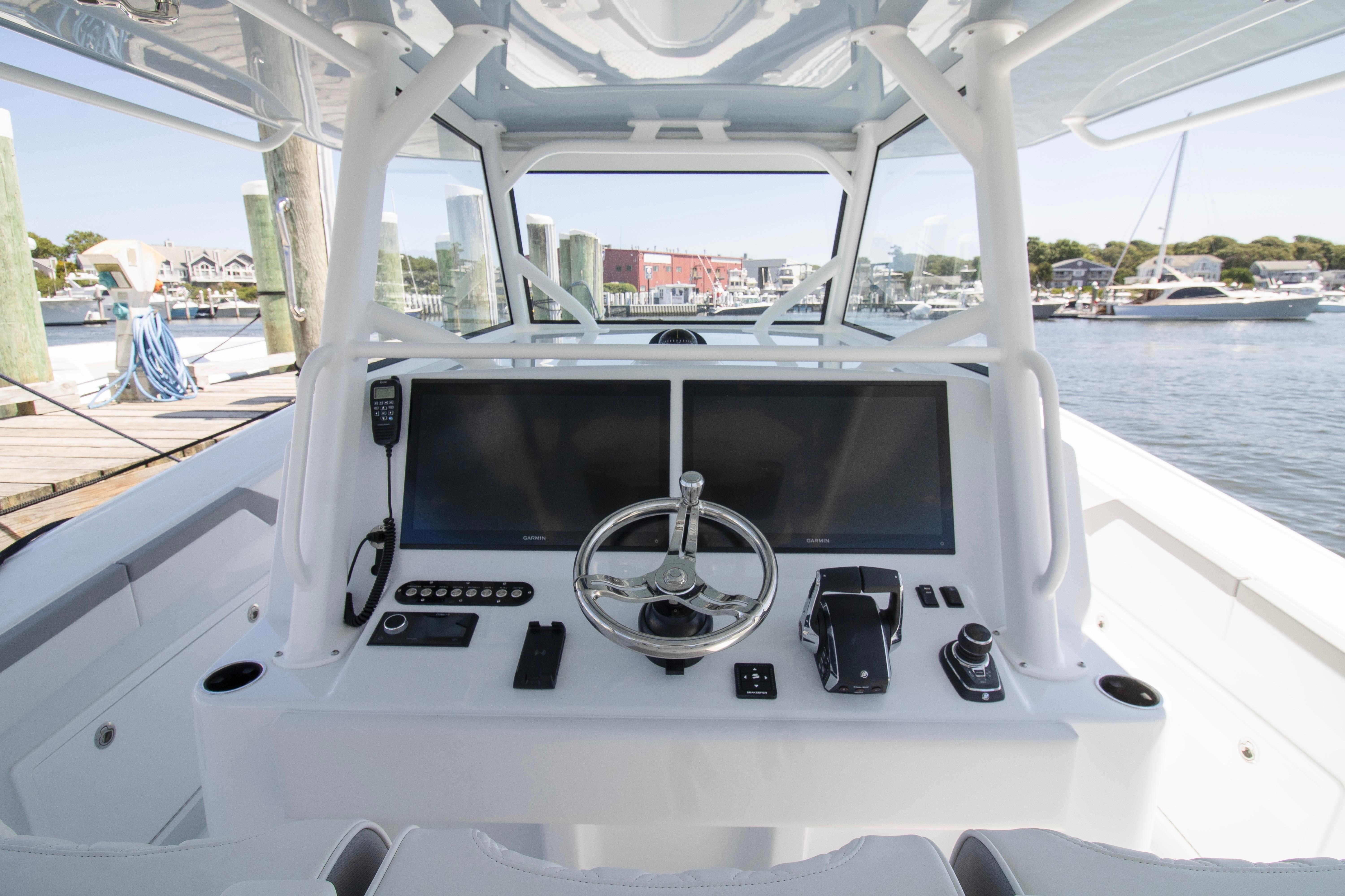 2026 Yellowfin 42 Offshore boat helm with dual screens and steering wheel.