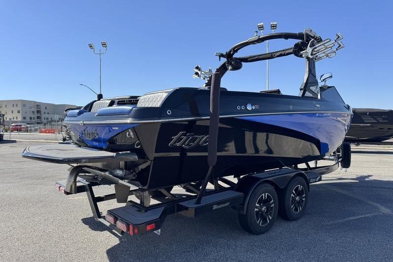 2022 Tigé Z3 boat on trailer in parking lot under clear blue sky.