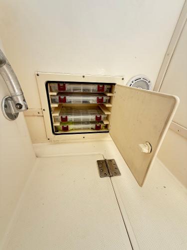 Storage compartment on a 2001 Albemarle 280 Express Sport Fisherman boat.