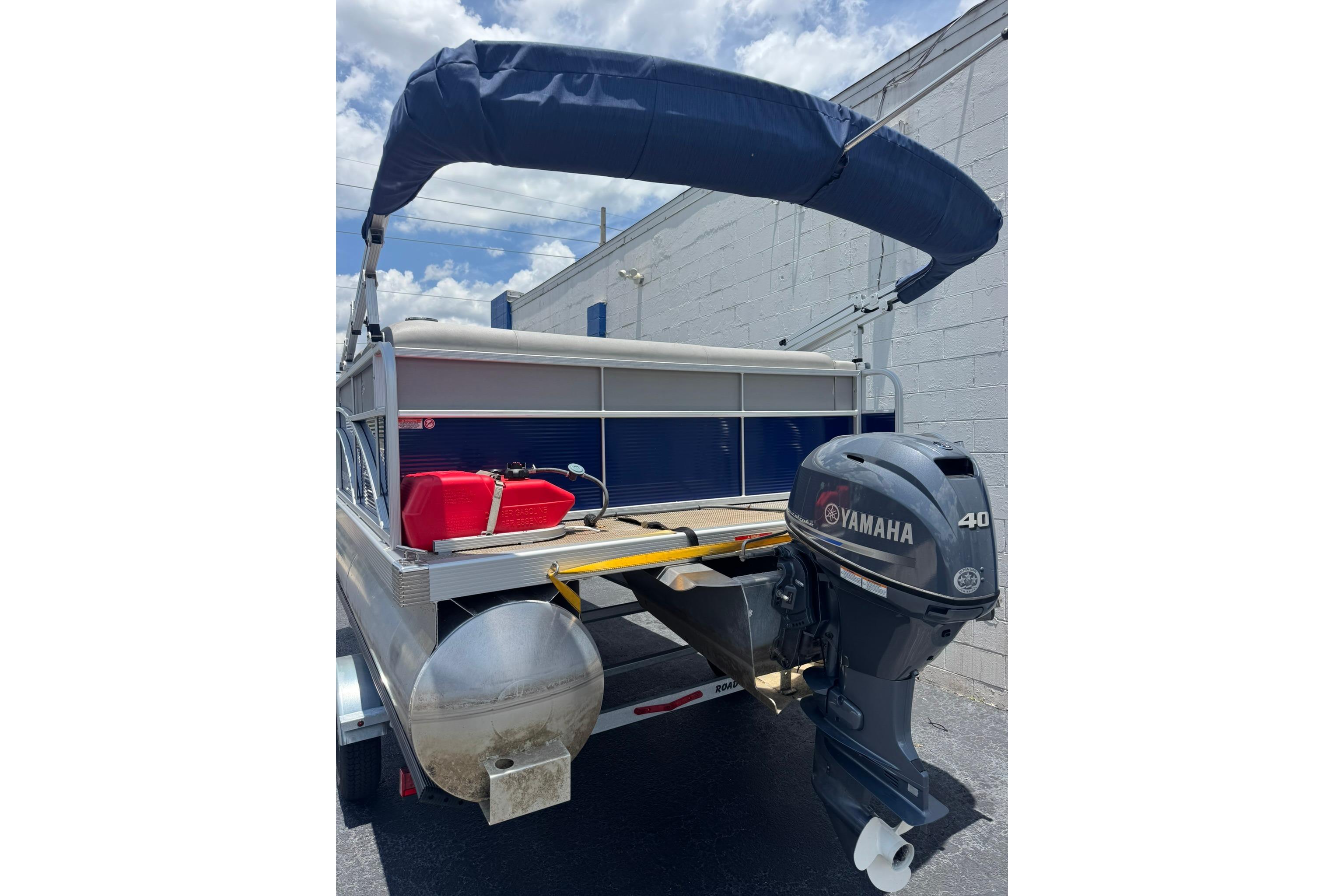 2024 Bennington SV 168 SLV pontoon boat with Yamaha 40 engine, blue canopy.
