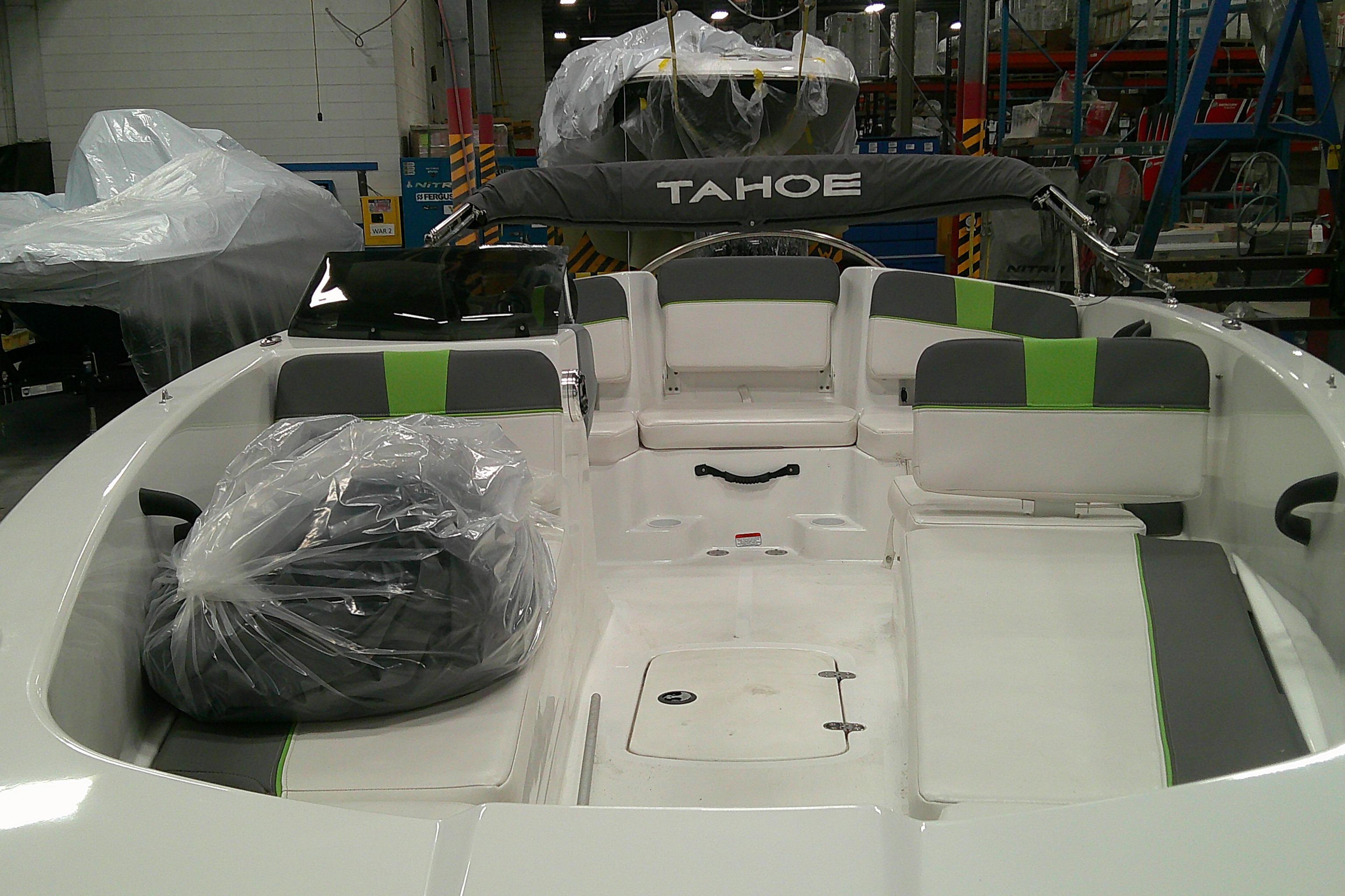 2023 Tahoe T18 boat interior with green accents, in a manufacturing facility.