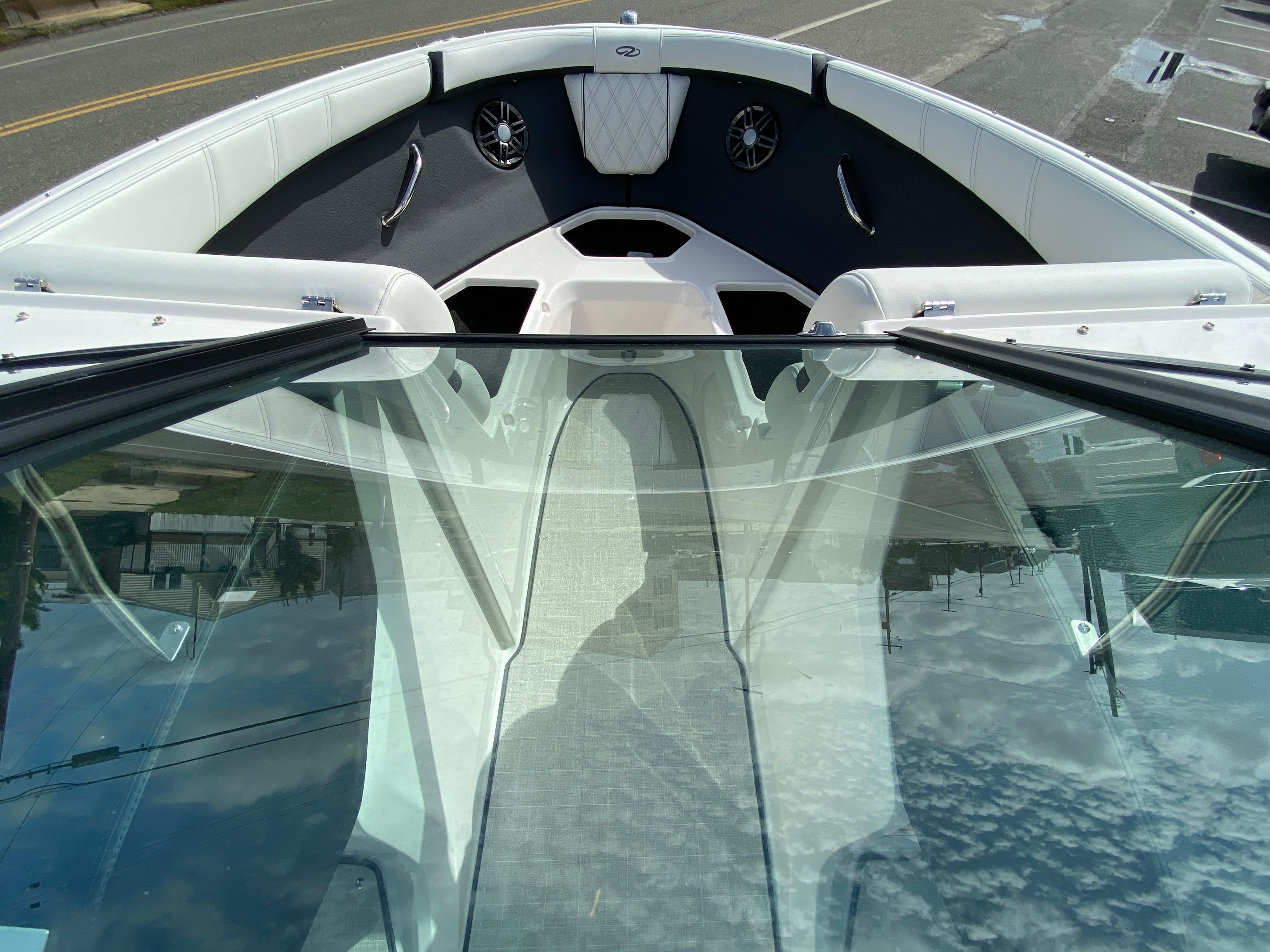 2026 Regal 21 OBX boat interior with white seating and glass windshield.