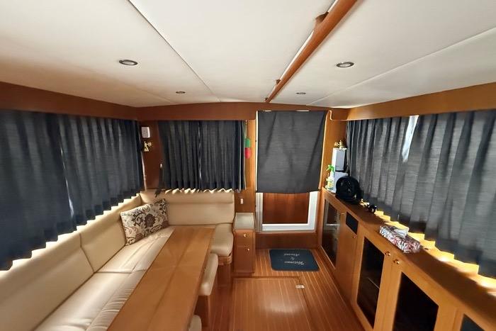 Interior of 2007 Island Pilot 395 yacht with wood accents and comfortable seating.