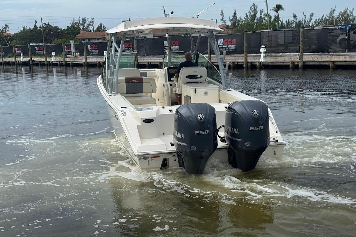 2020 Cobia 280 Dual Console boat with twin Yamaha 250 engines on water.