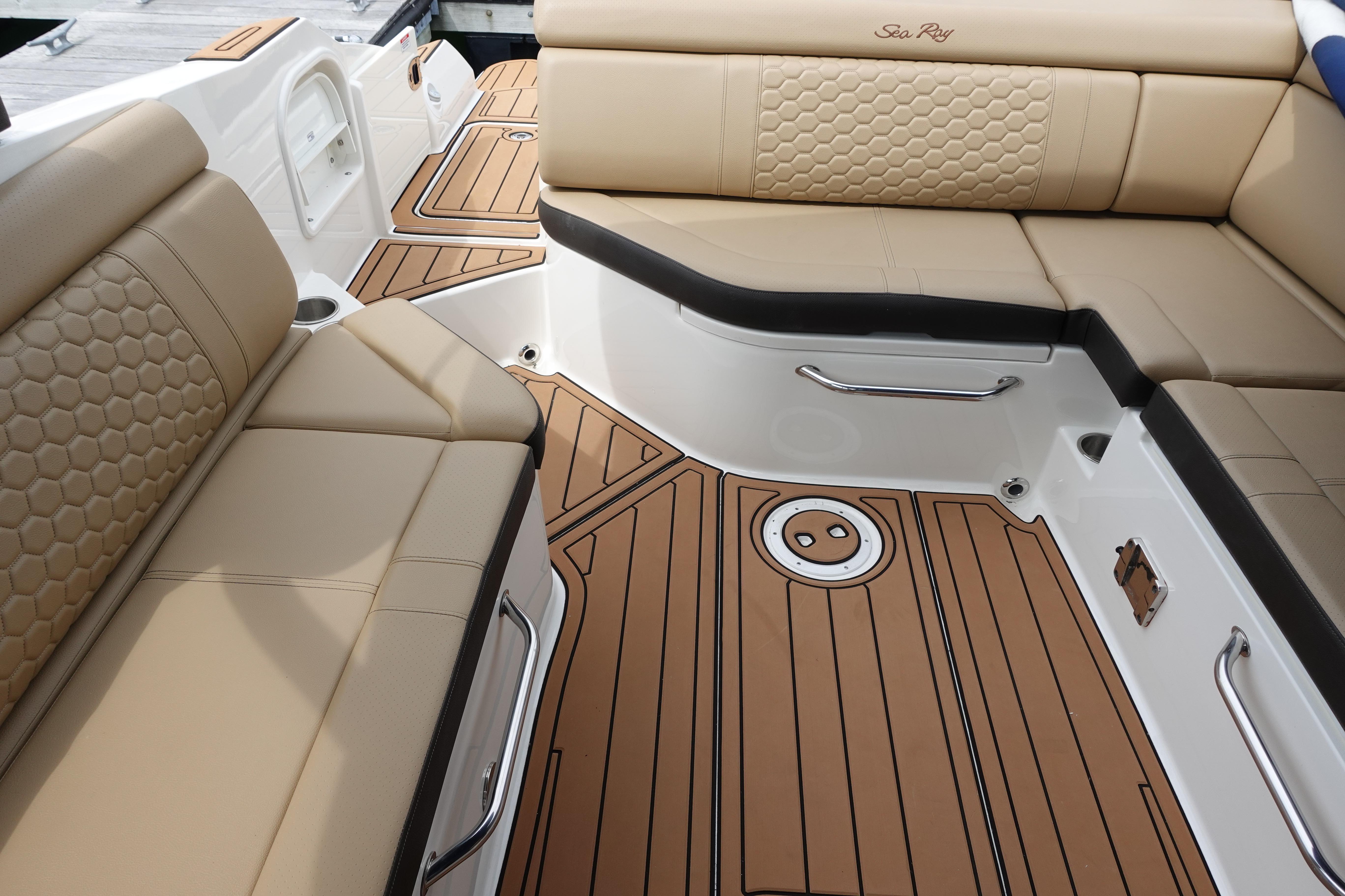 2018 Sea Ray SDX 270 boat interior with tan leather seating and teak-style flooring.