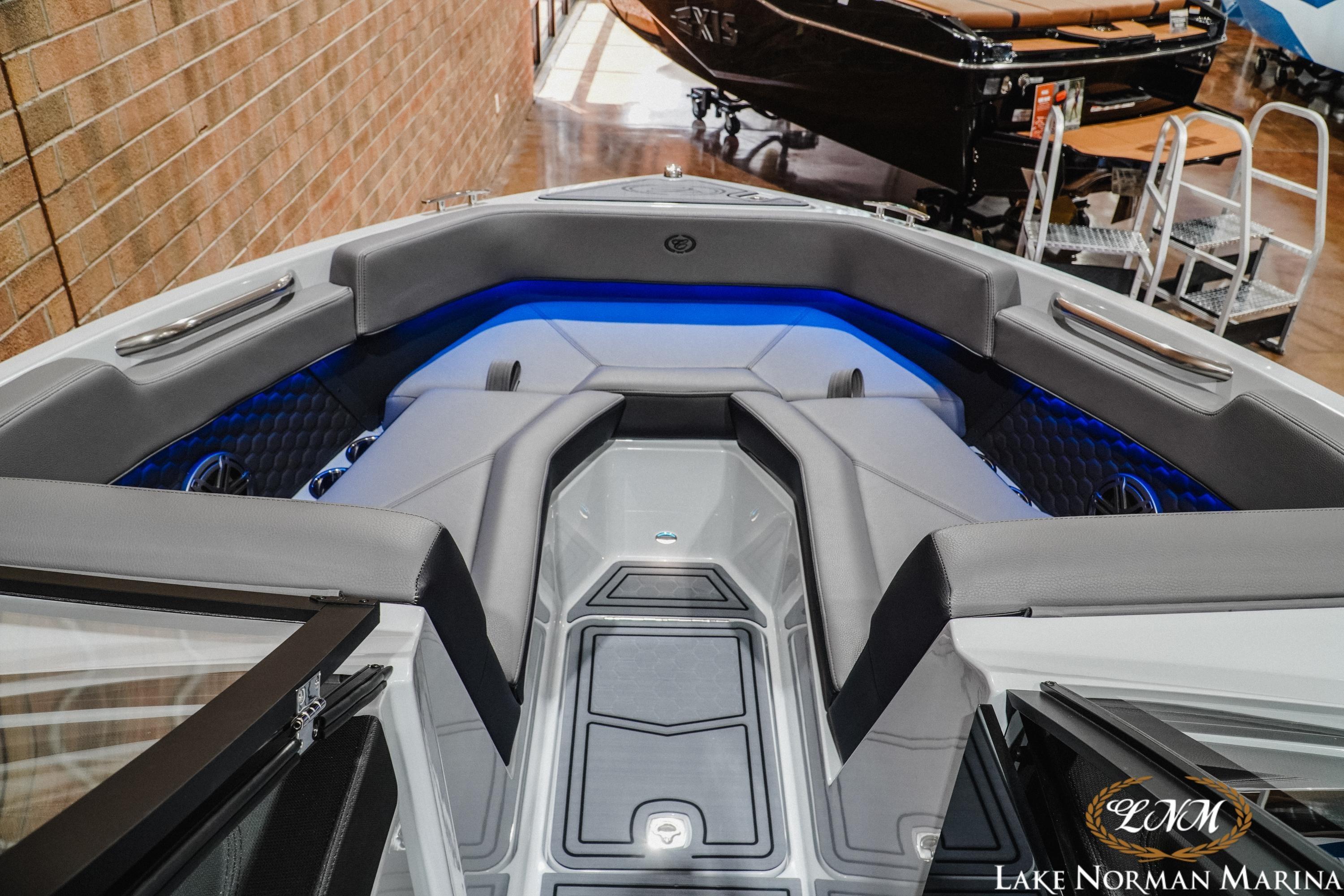 2026 Cobalt R4 Surf boat interior with sleek seating and ambient blue lighting.