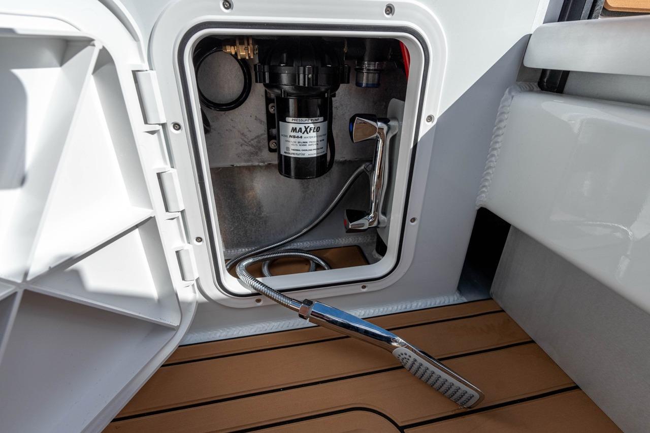 Makaira Gen 3 36 (2025) boat compartment with MaxFlo pressure pump and shower head.