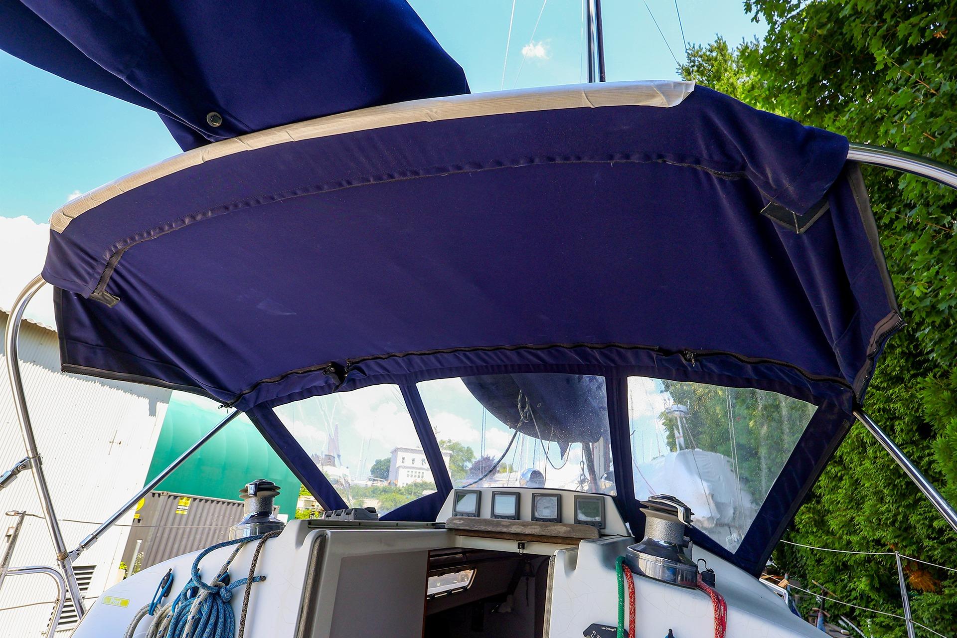 2001 J Boats J/32 sailboat cockpit with blue canvas cover and ropes.