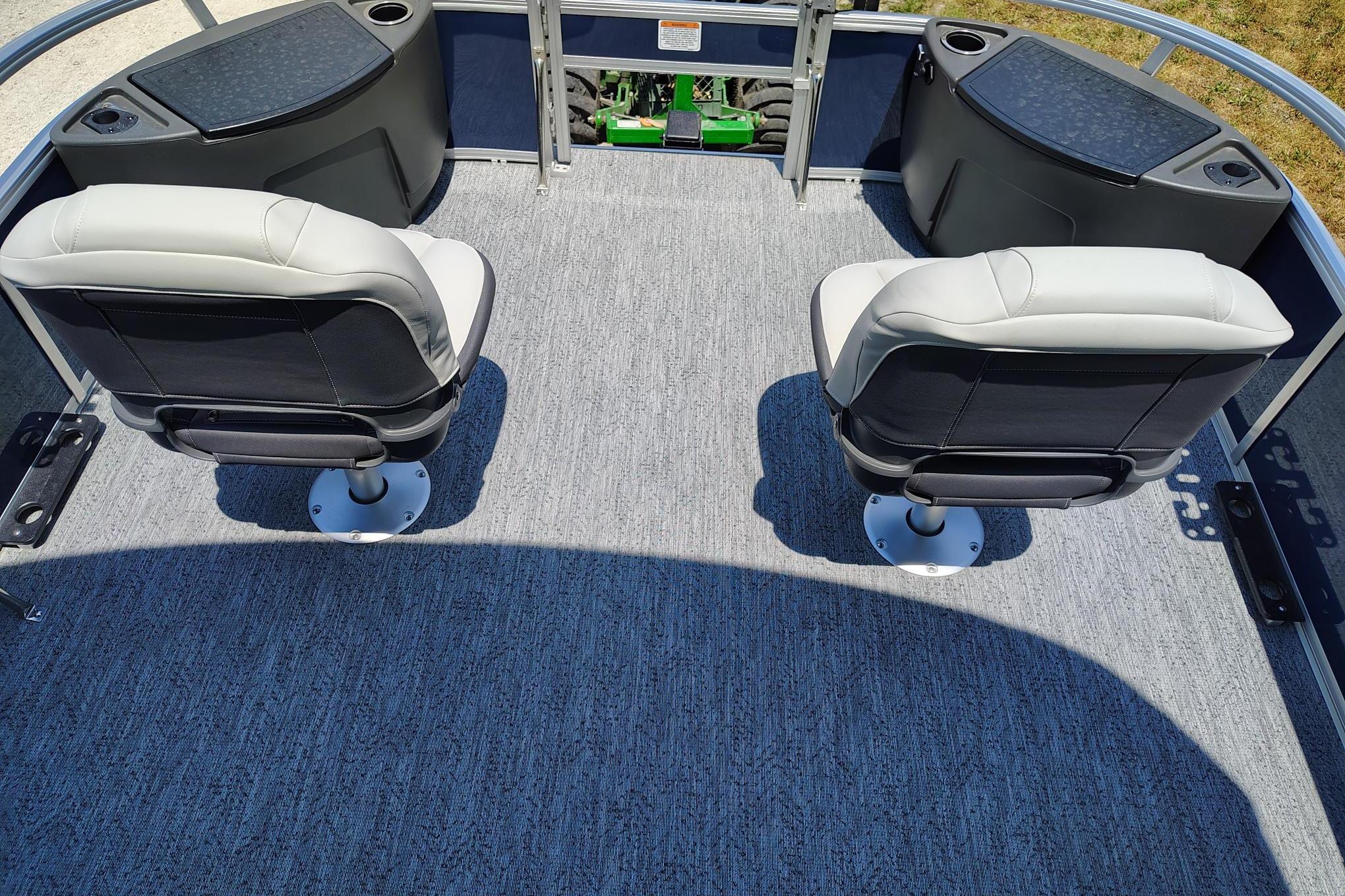 2026 Sun Tracker Bass Buggy 18 DLX interior with two swivel seats and carpeted flooring.