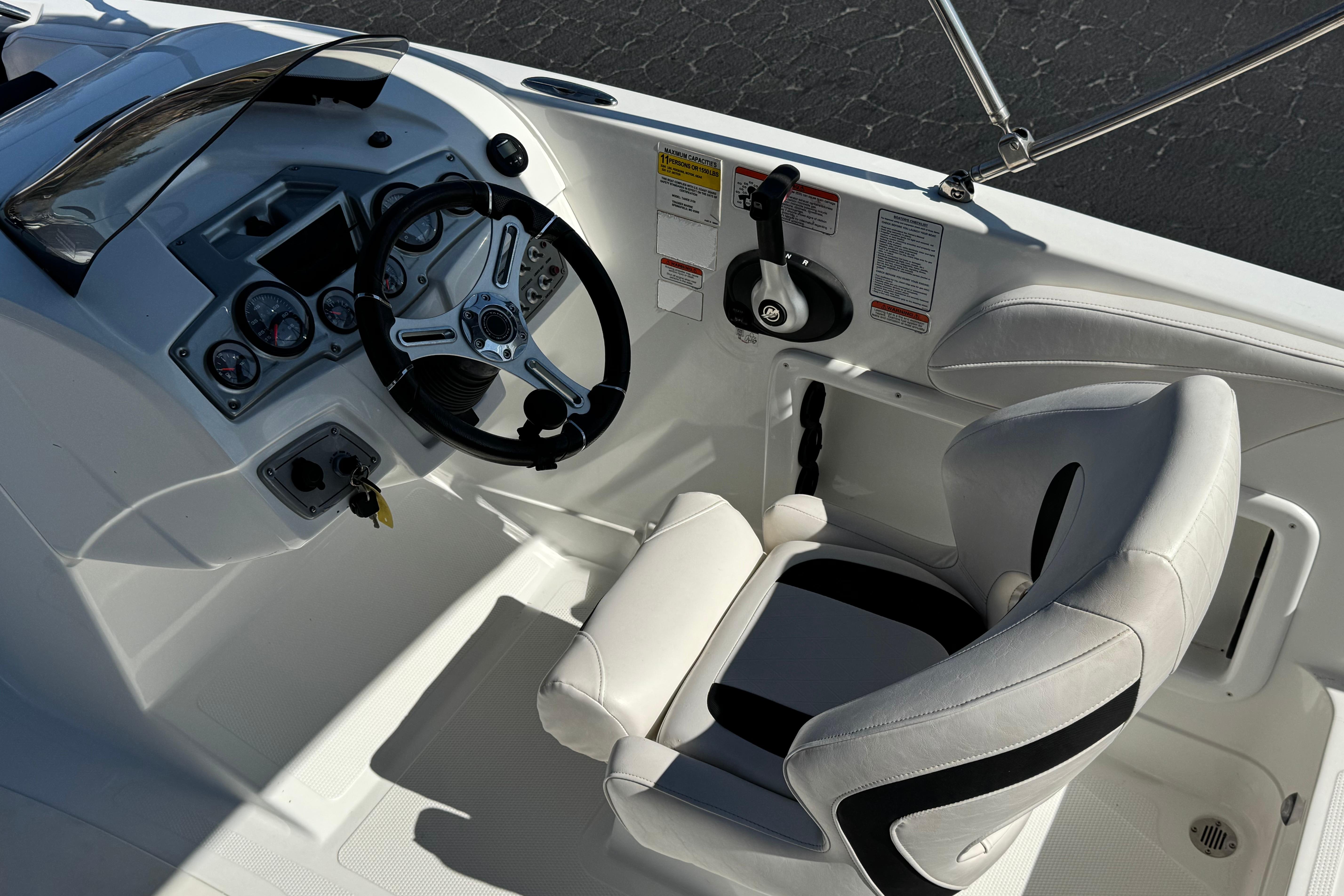Cockpit of 2019 Tahoe 2150 boat with steering wheel and control panel.