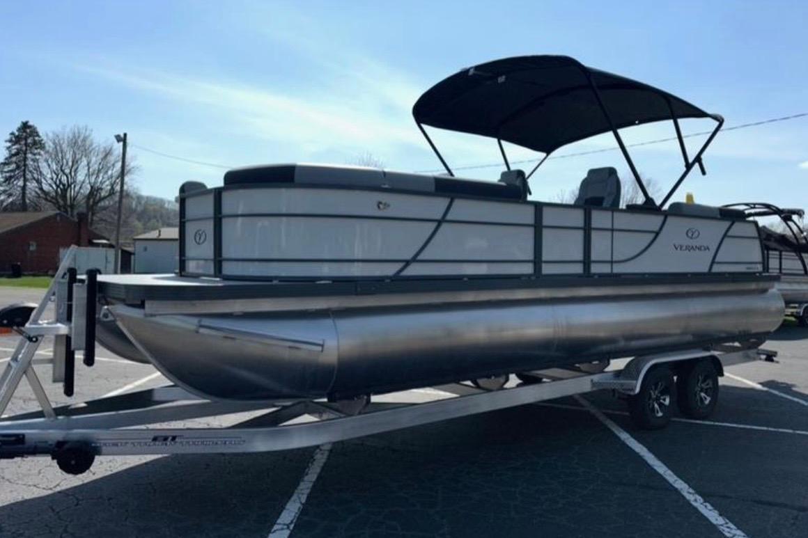 2025 Veranda Relax VR25VLC pontoon boat on trailer, parked outdoors under clear sky.