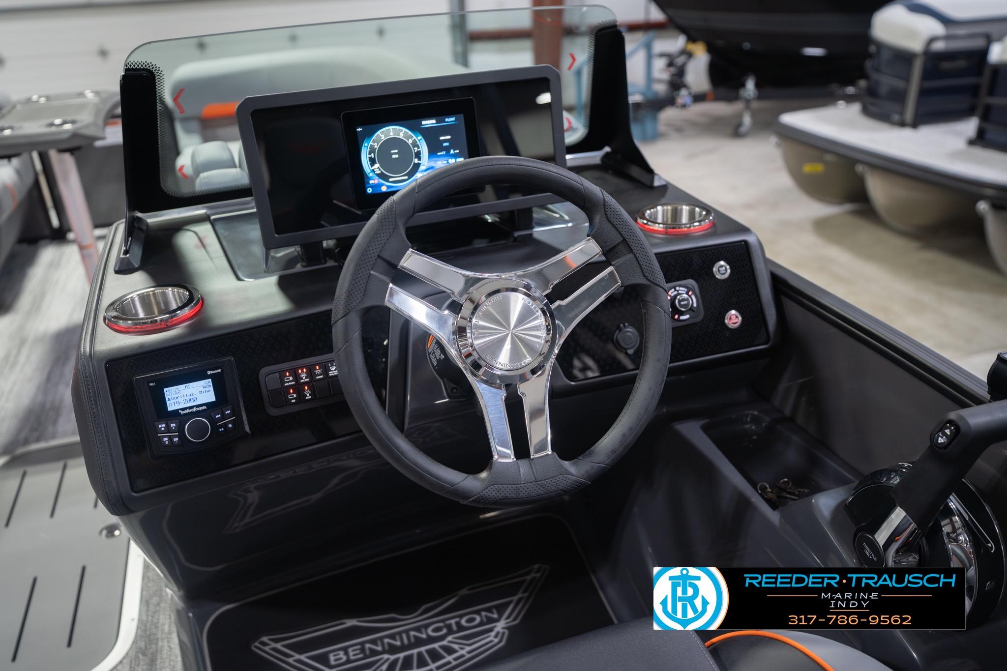 2026 Bennington 24 MSB boat dashboard with steering wheel and digital display.