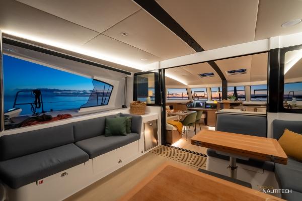 Luxurious interior of 2025 Nautitech 48 Open catamaran with modern seating and ocean view.