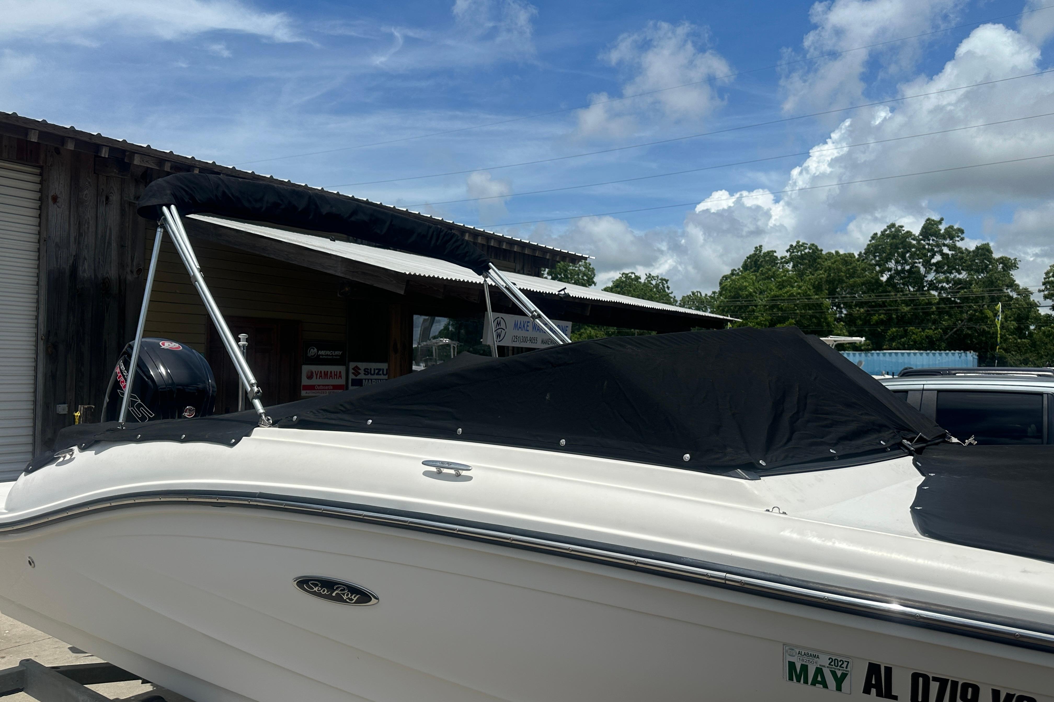 2017 Sea Ray SPX 190 Outboard boat with black cover, parked outdoors under blue sky.