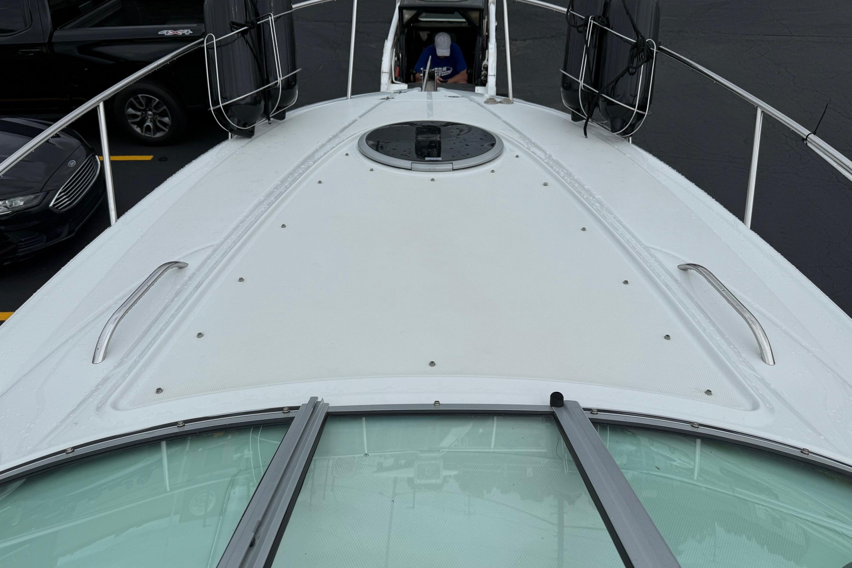 2005 Crownline 250 CR boat deck with railing and hatch, viewed from above.