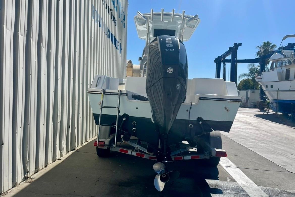2025 Defiance Catalina 240 boat with powerful outboard motor on trailer in marina.