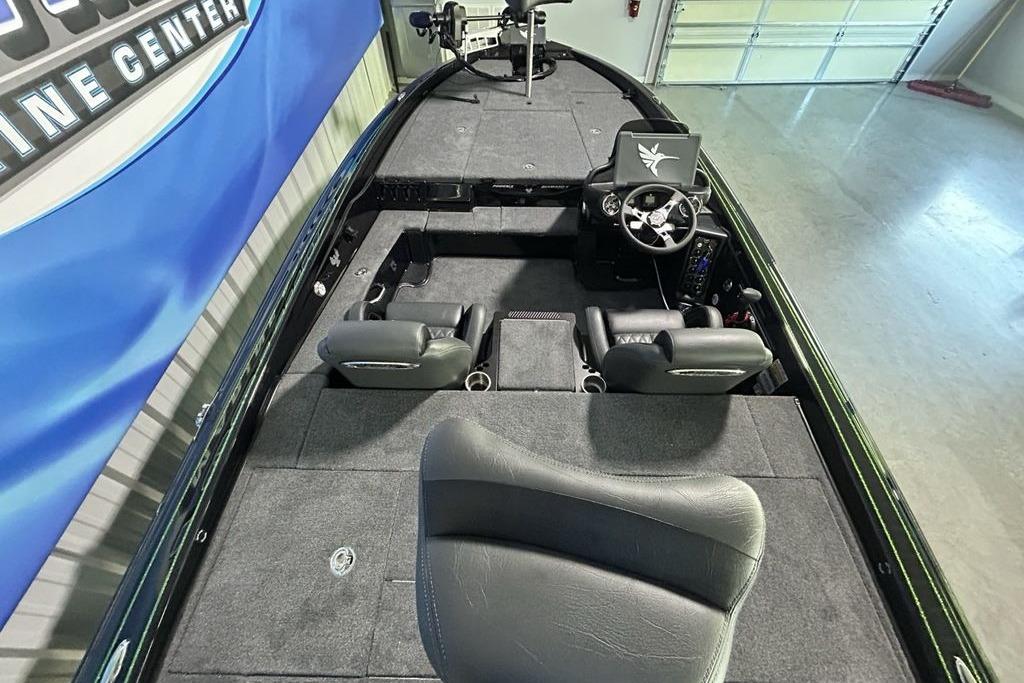 2026 Phoenix 819 ZXL boat interior with steering wheel and seating in a showroom.