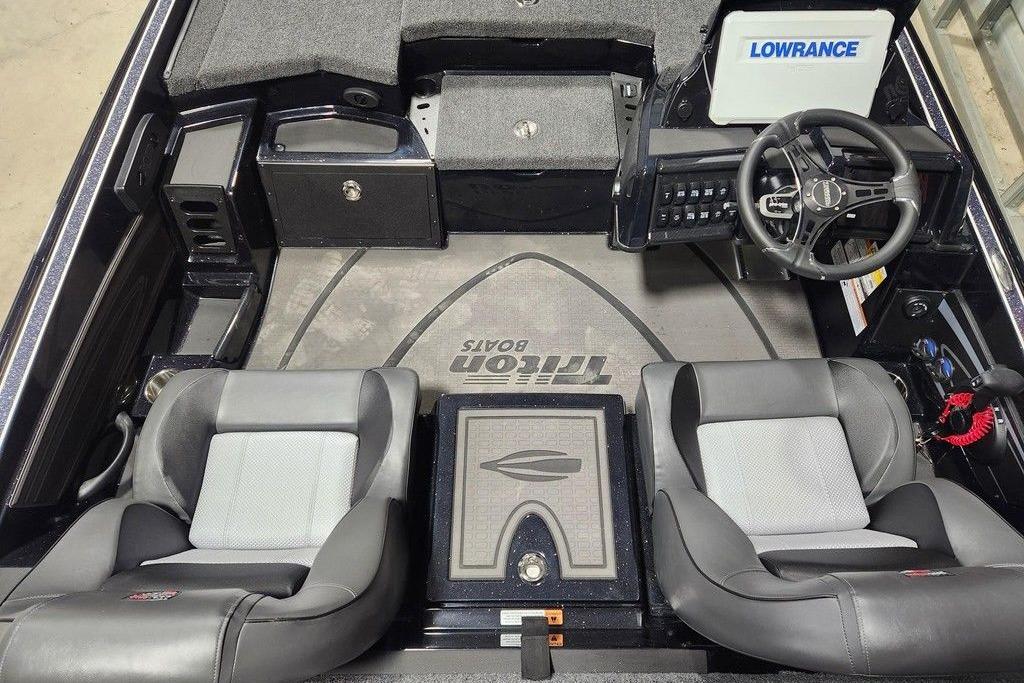 2026 Triton 20XP Patriot boat interior with steering wheel and seating.