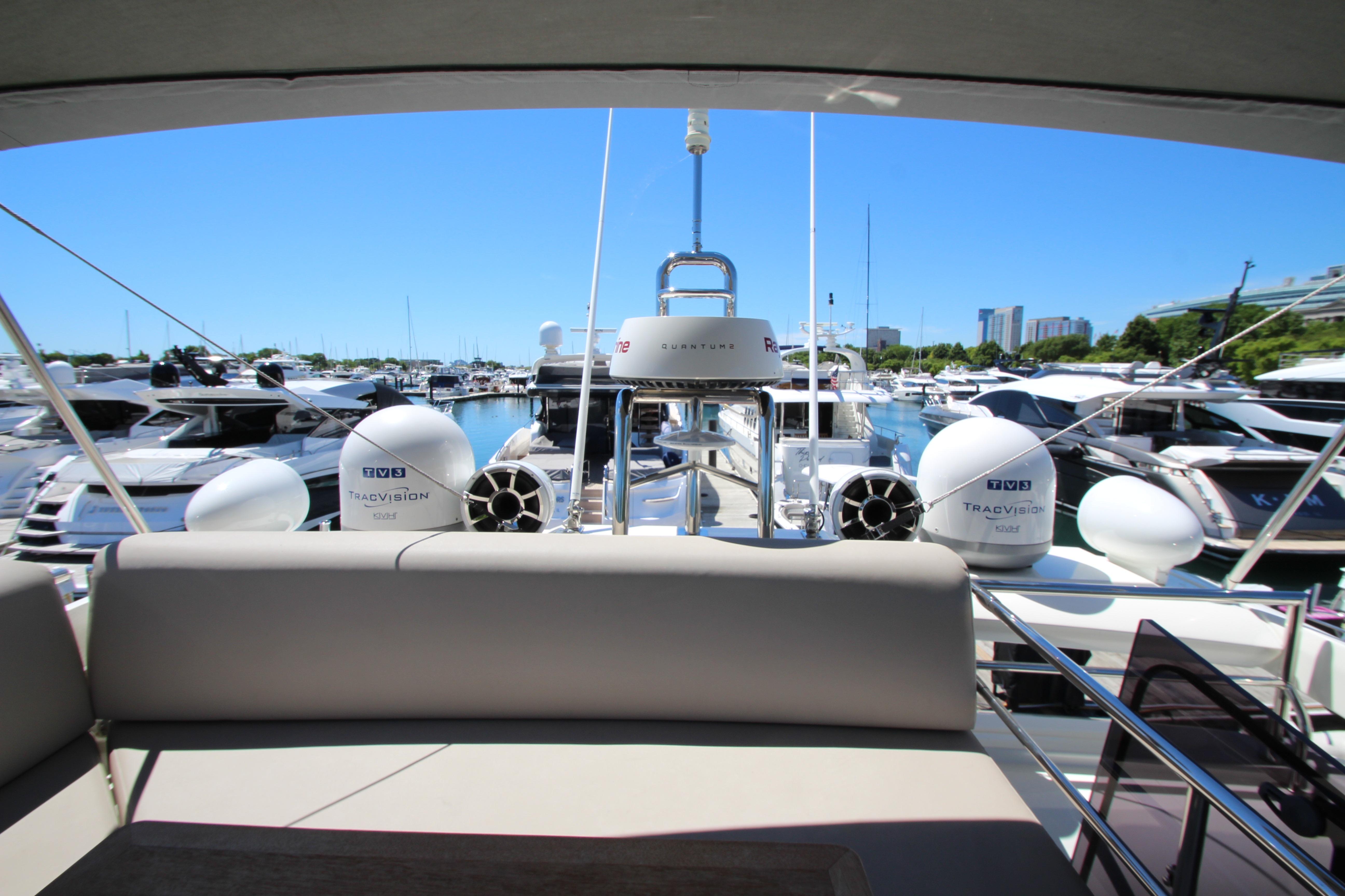 Prestige 520 yacht, 2022 model, docked in a marina with clear blue skies.