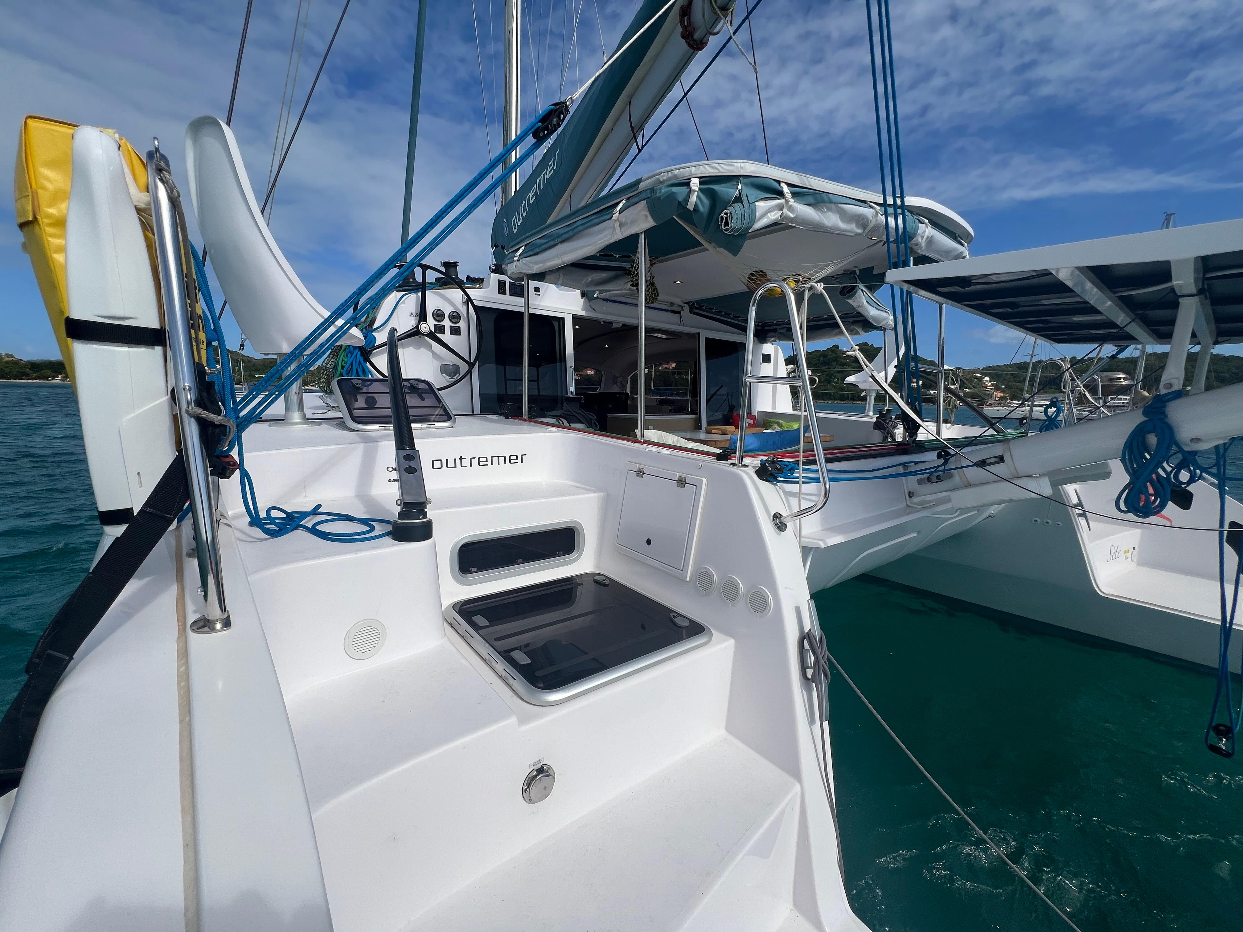 2024 Outremer 45 catamaran with sleek design, docked in clear blue waters.