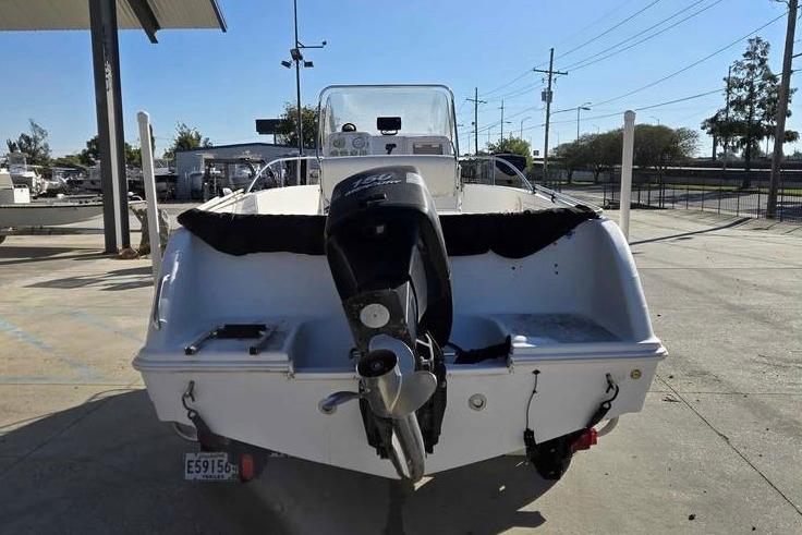 2001 Pro-Line 19 Sport boat with outboard motor, parked in a marina.