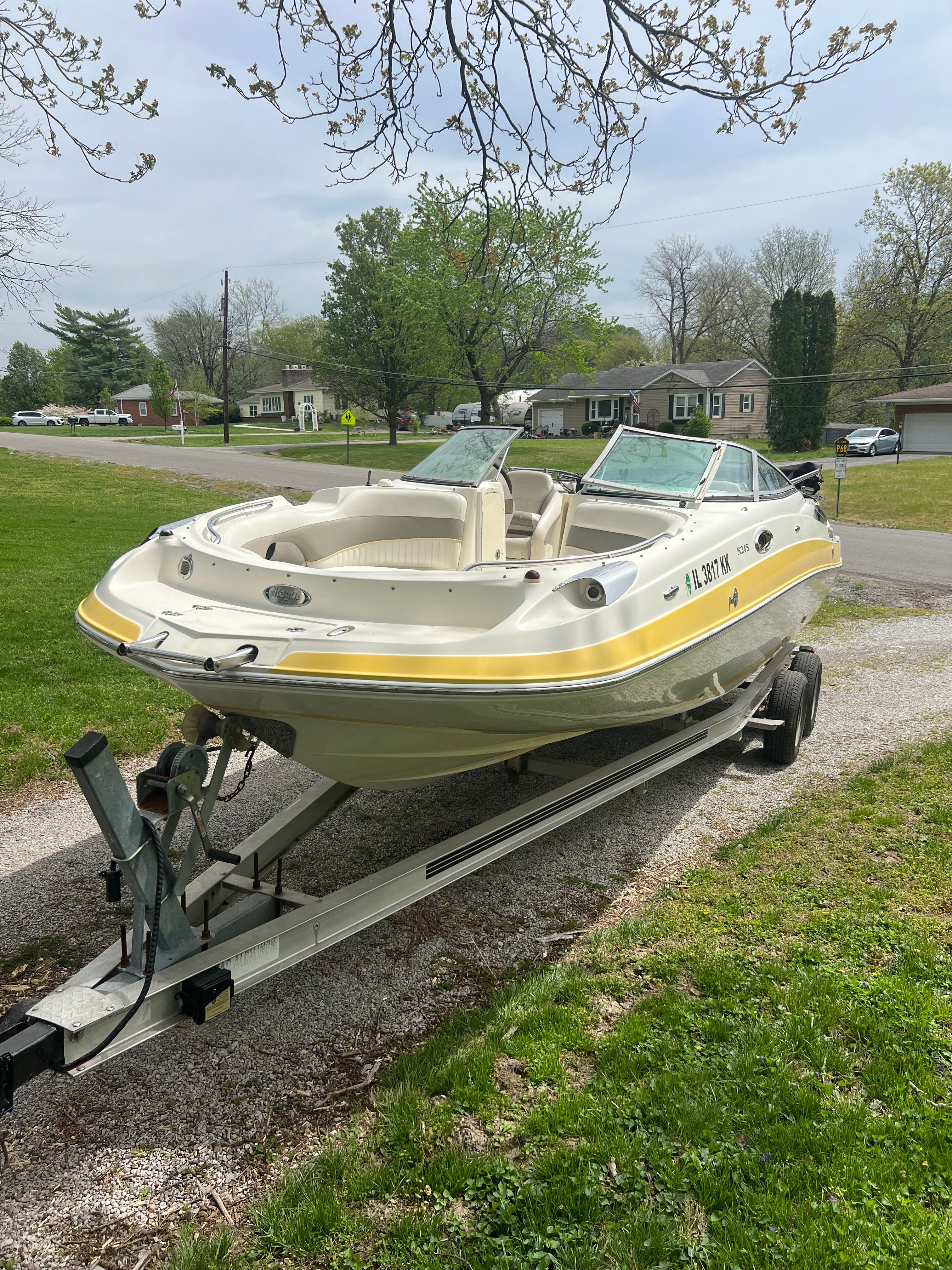 2007 Harris-Kayot S245 boat parked on trailer outdoors.