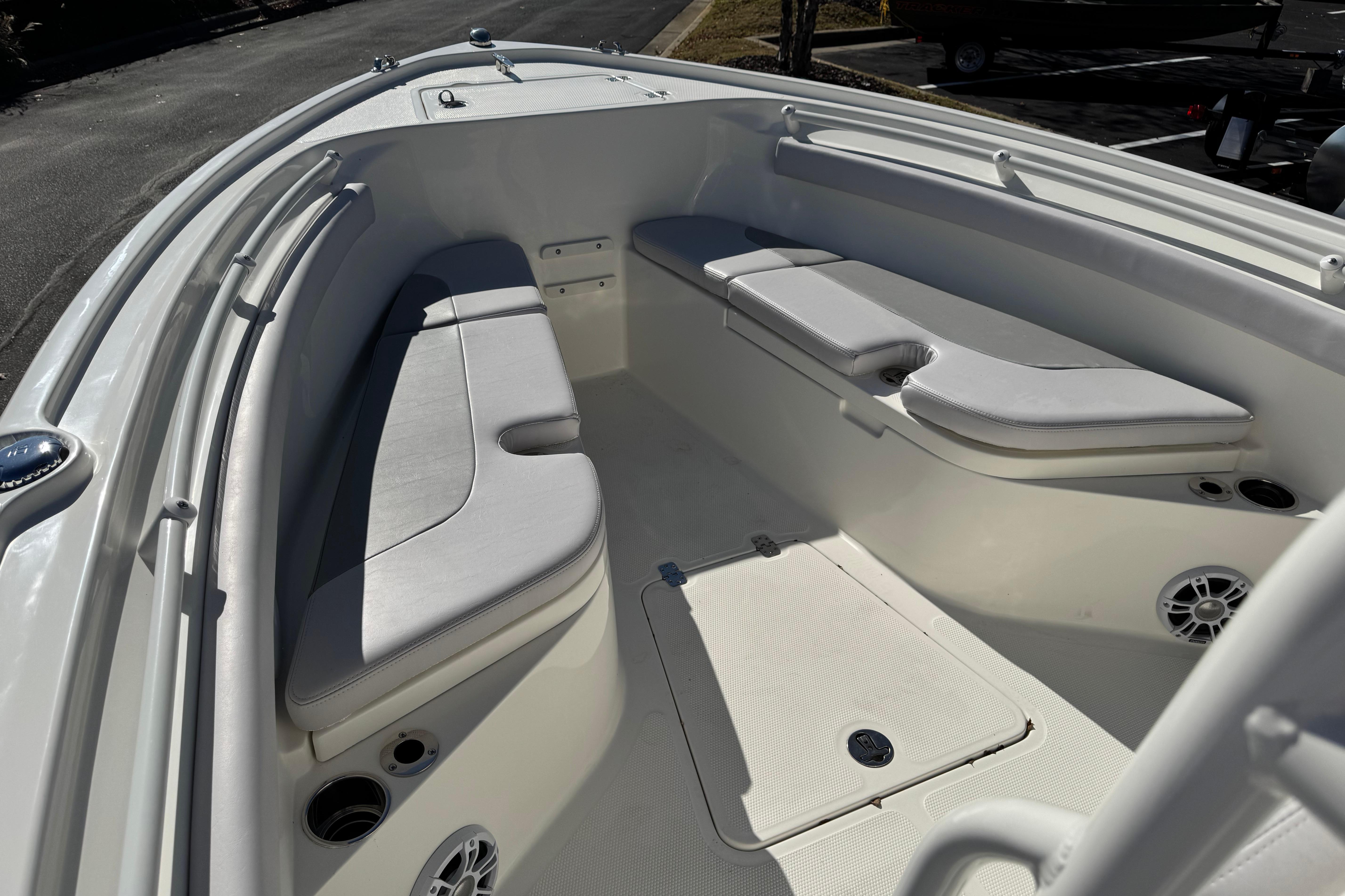 2026 Mako 214 Center Console boat interior with cushioned seating and storage compartments.