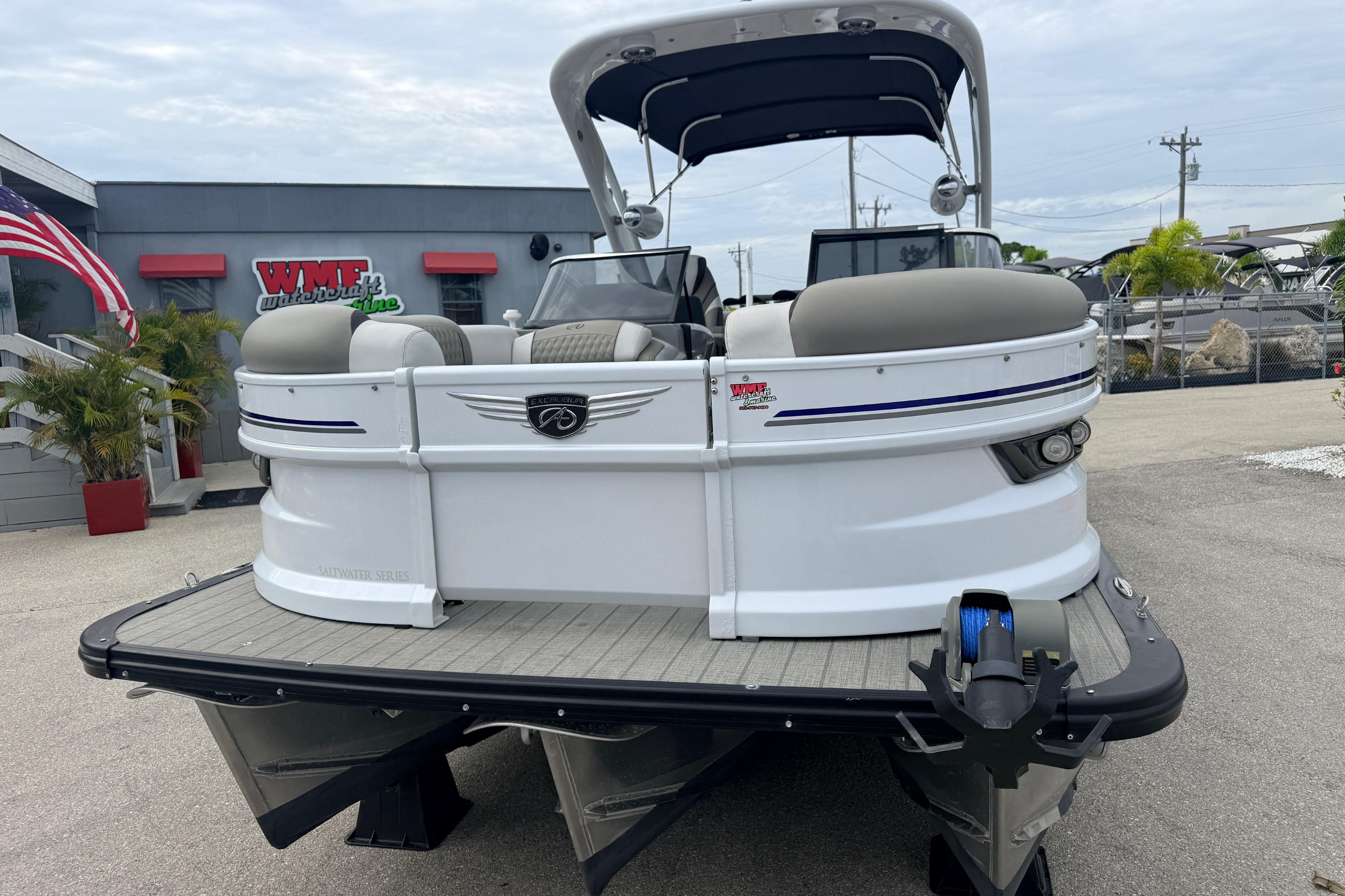 2023 Avalon Excalibur 2585 Windshield Elite Tri Toon boat at dealership, front view.