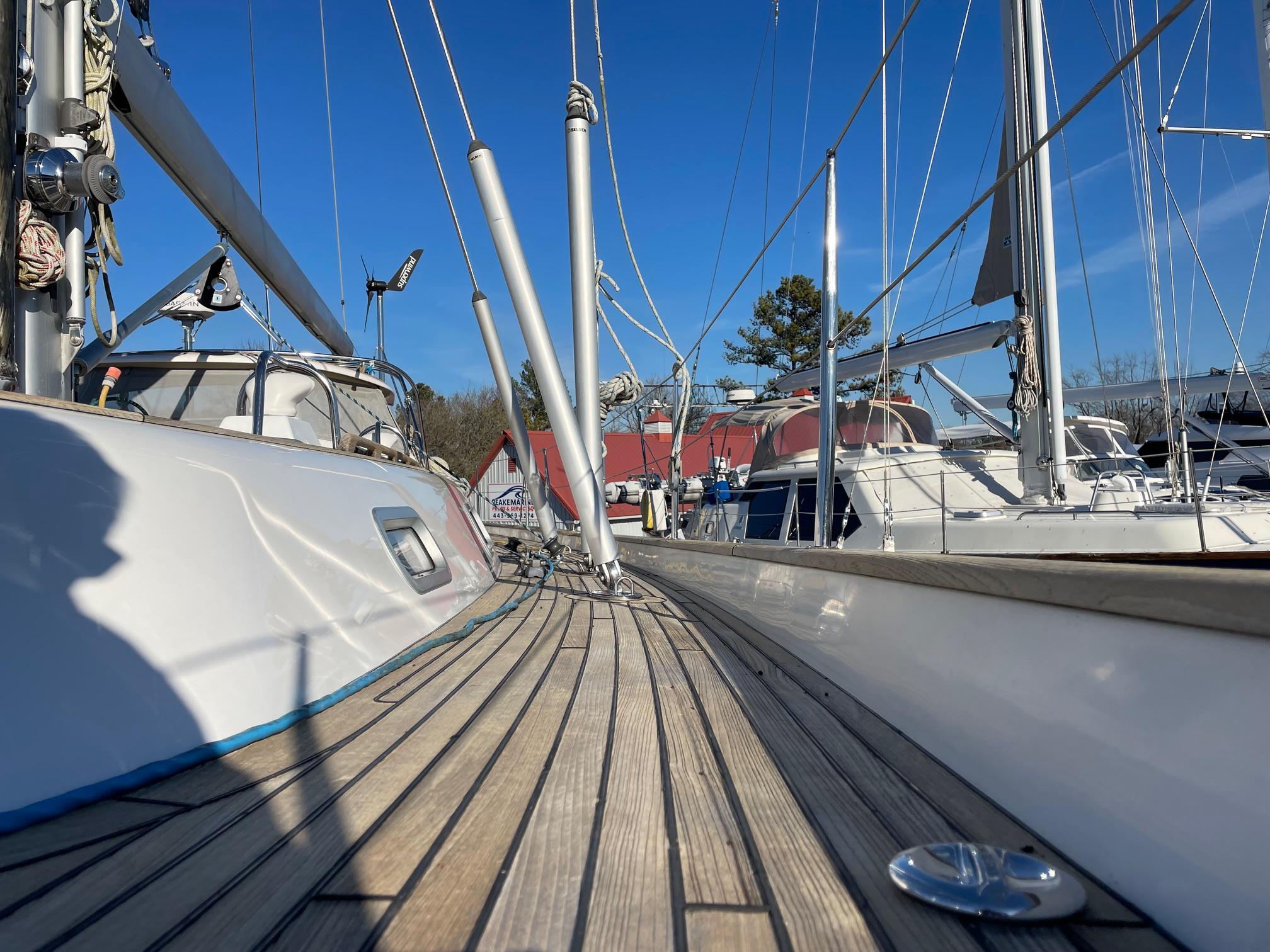 2009 Hallberg-Rassy 54 sailboat deck with clear blue sky background.