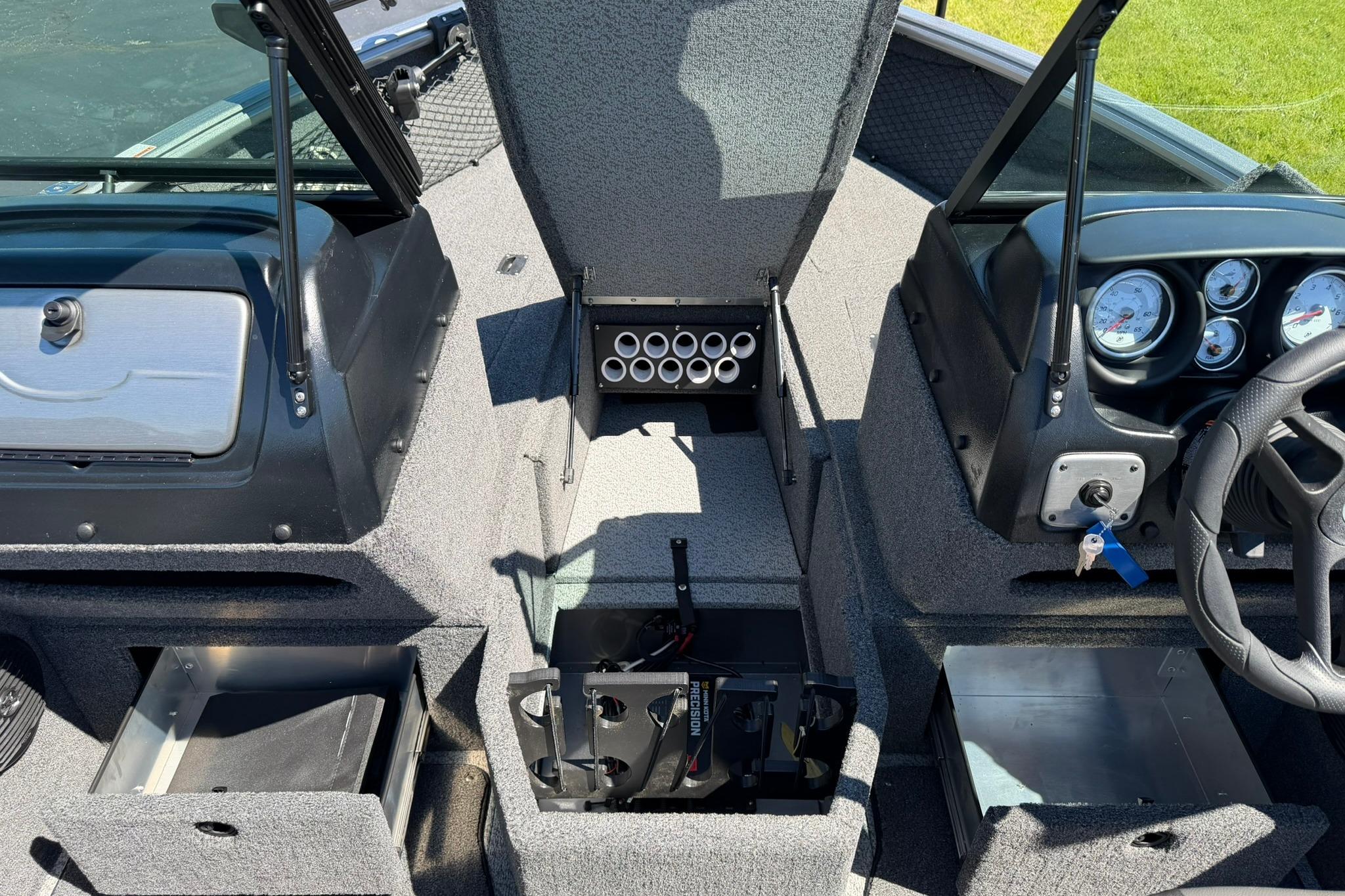 2024 Lund 1875 Impact XS Sport boat interior with storage compartments and control panel.