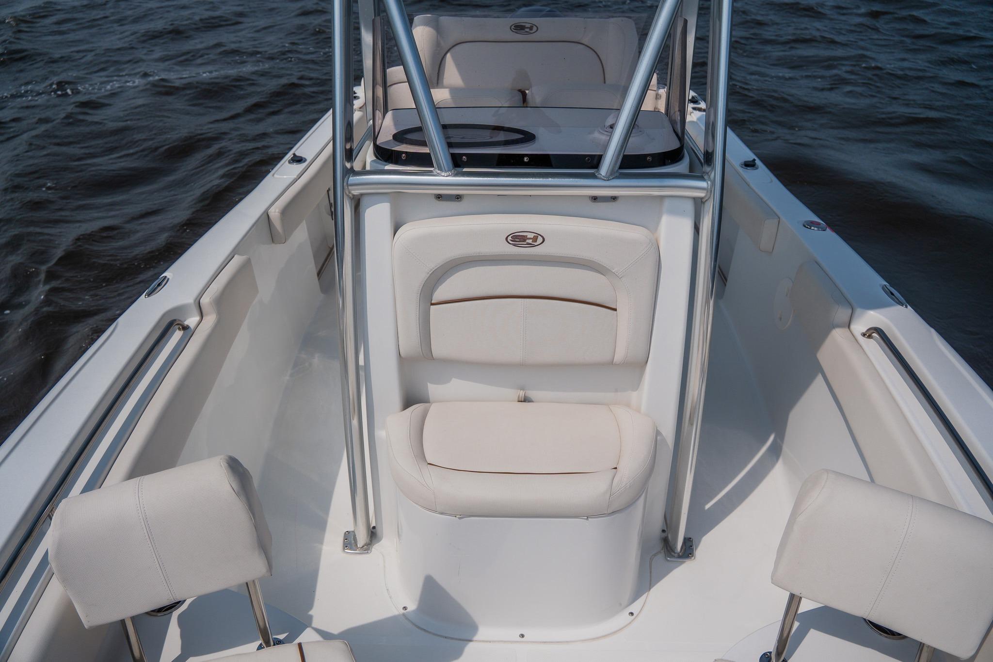 2022 Sea Hunt Ultra 229 boat interior with white seating on open water.