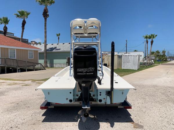 2013 SCB R24 boat with Mercury 250XS outboard motor, parked near beach houses.