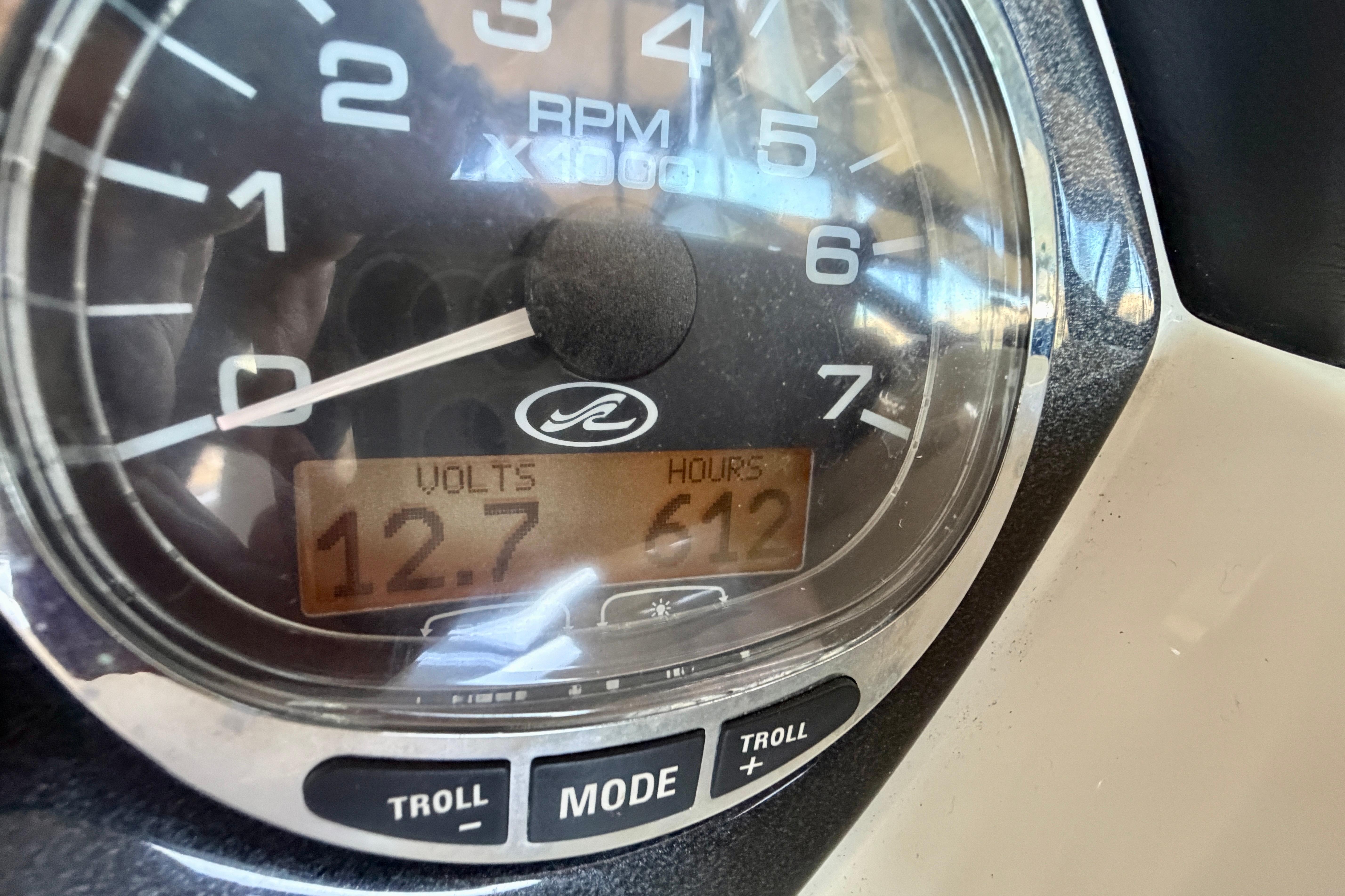 Close-up of 2007 Sea Ray 270 SLX gauge showing 12.7 volts and 612 hours.