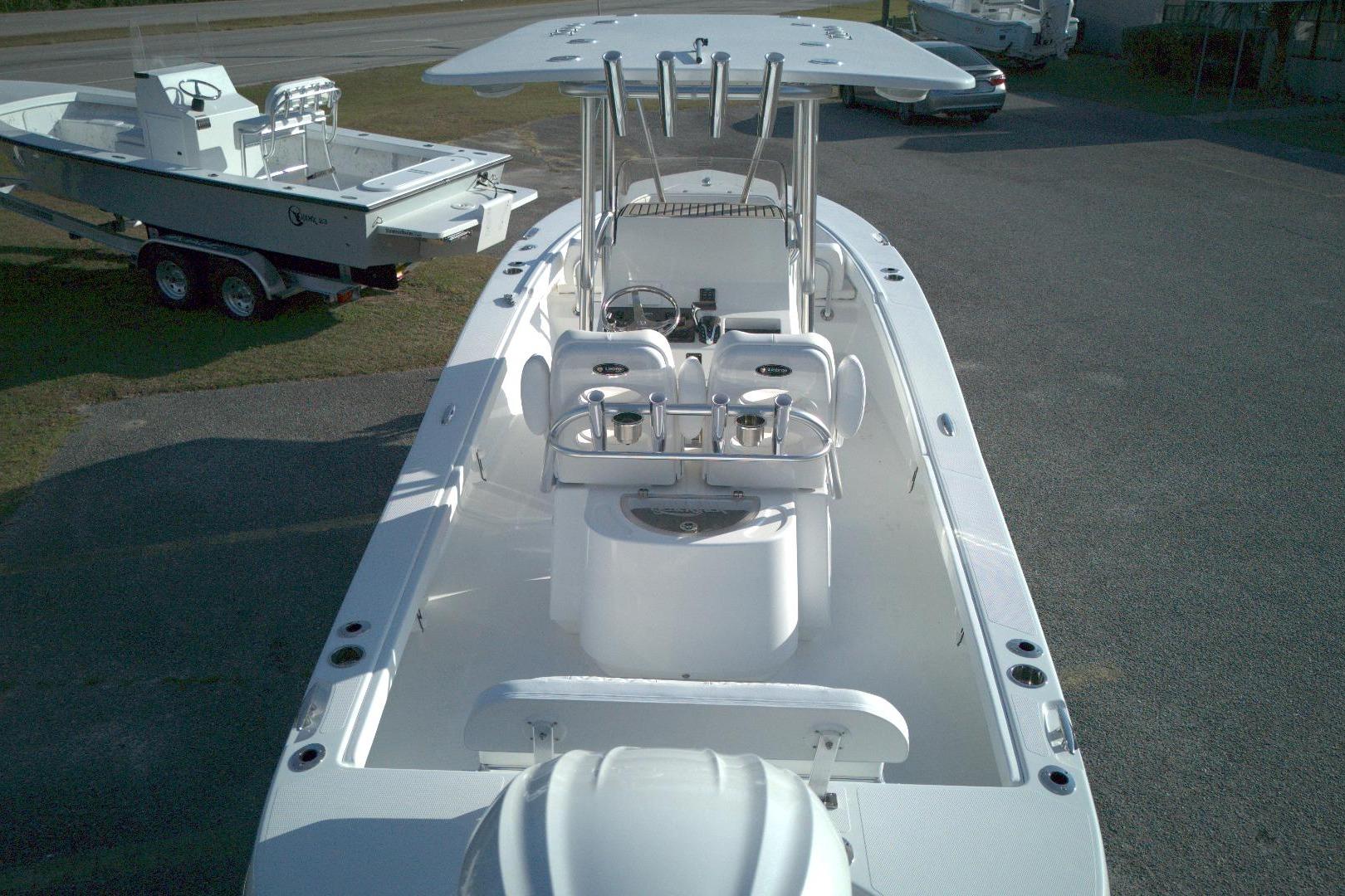 2026 BlackJack 256 Coastal boat with T-top and center console, parked on a trailer.