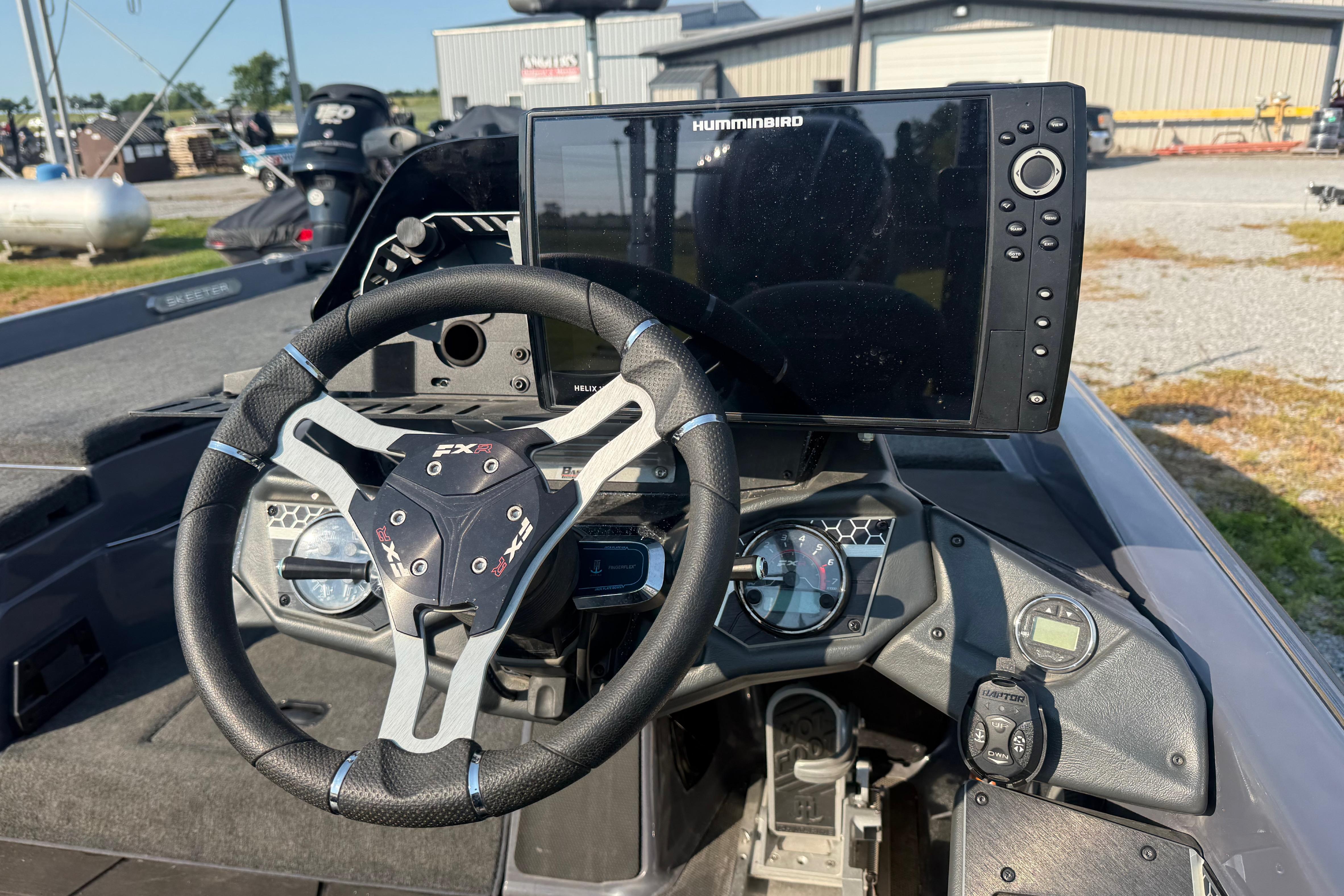2024 Skeeter FXR21 boat dashboard with steering wheel and Humminbird navigation system.