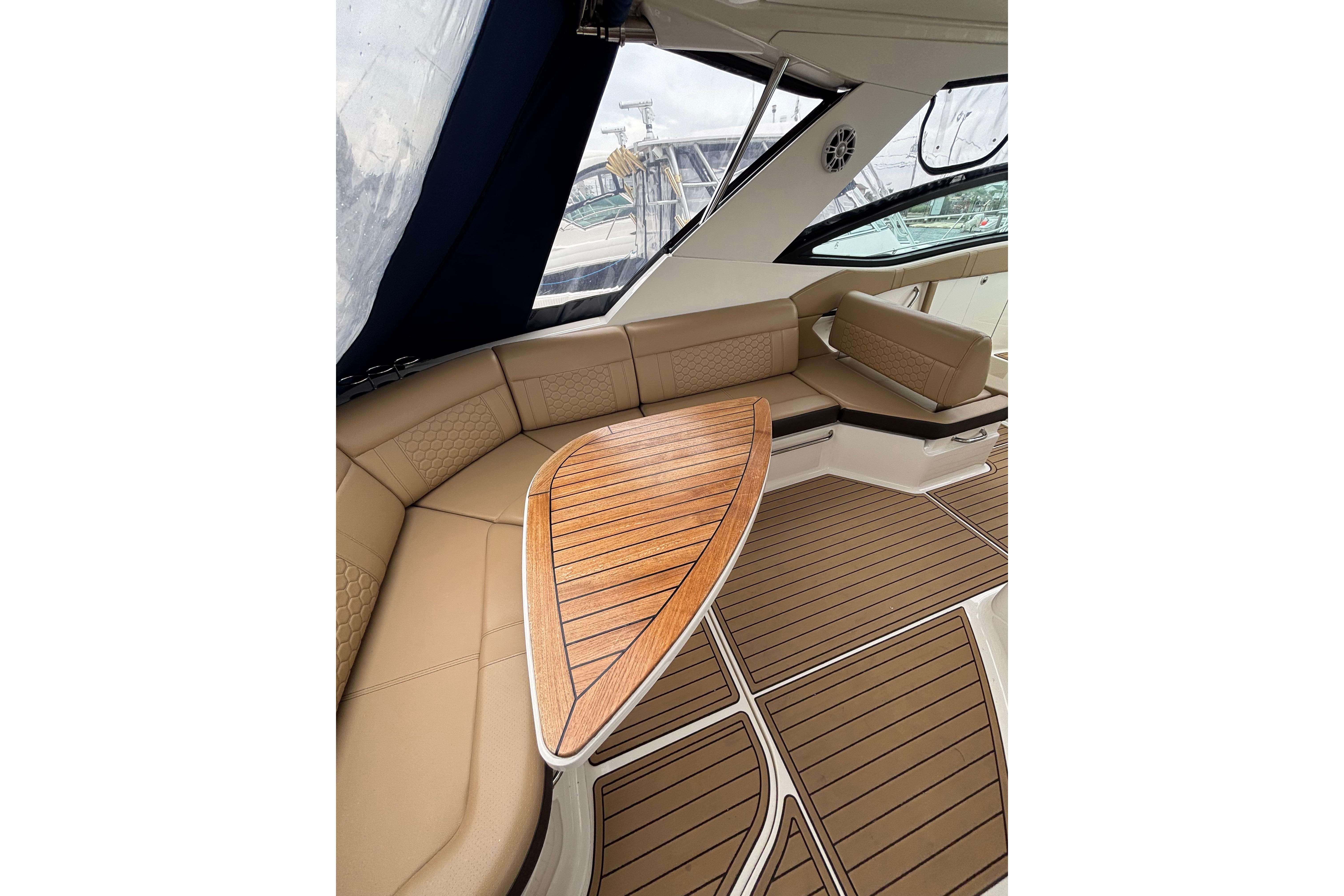 Luxurious interior of 2021 Sea Ray Sundancer 320 Outboard with elegant seating and wooden table.