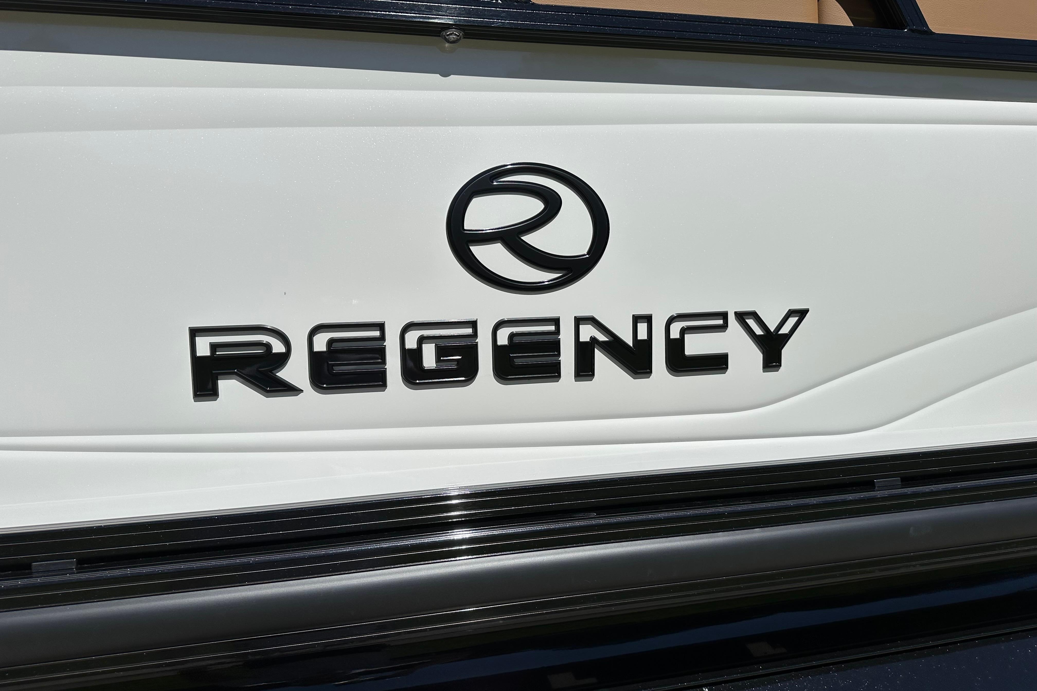 2026 Regency 230 DL boat logo on white surface.