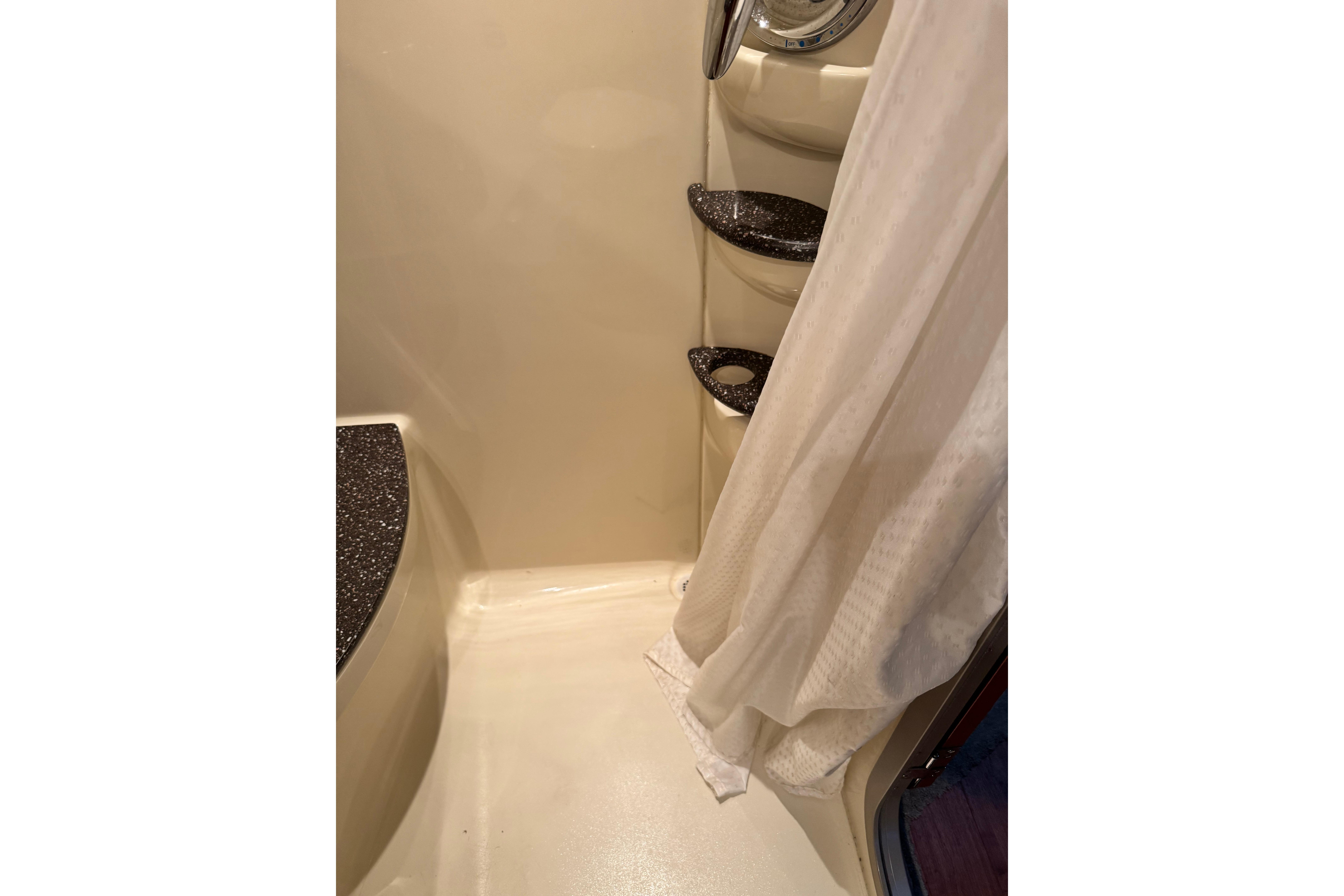 Shower area in 2008 Formula 400 Super Sport boat with curtain and shelves.