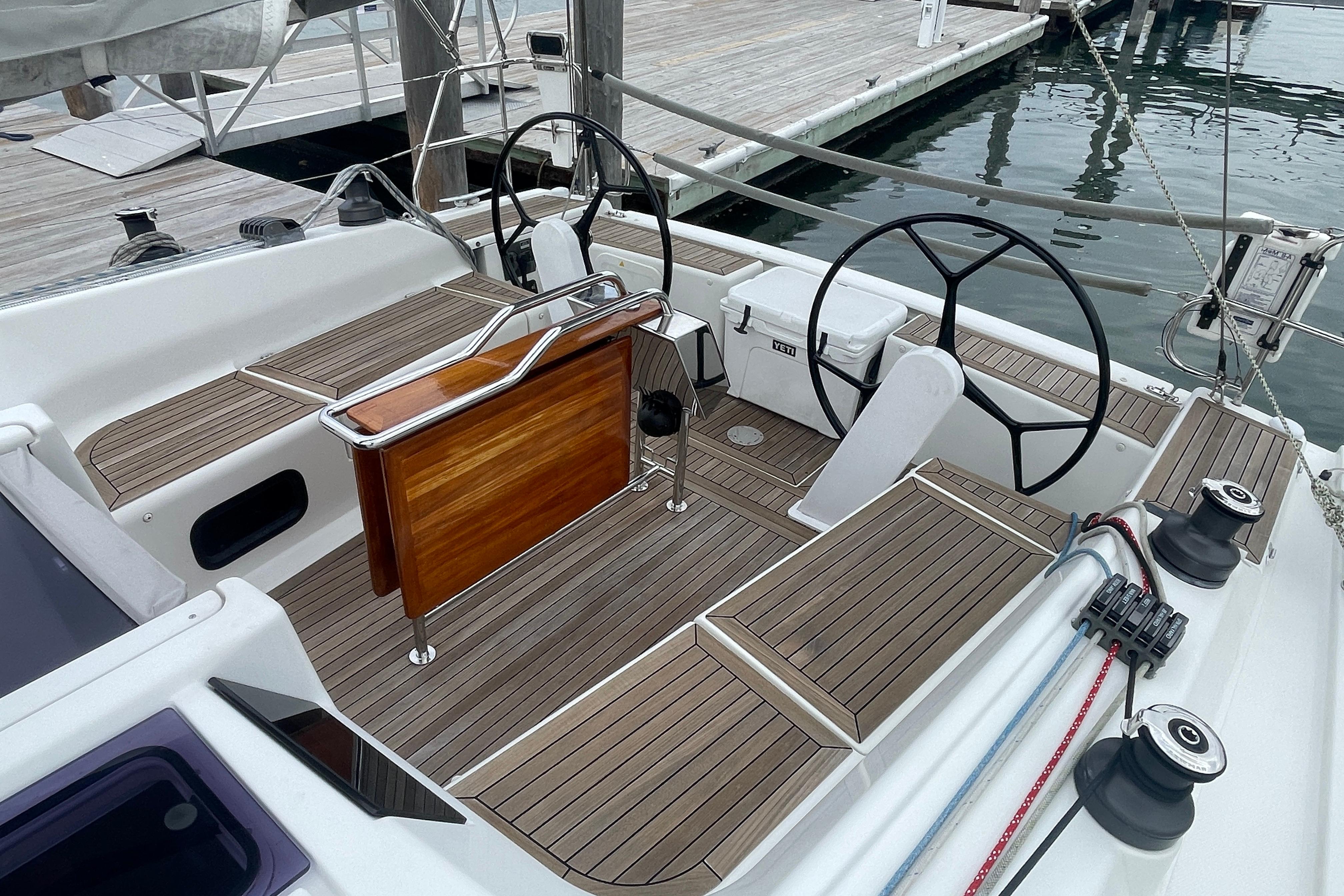 Cockpit of 2014 Hanse 415 sailboat with dual steering wheels and teak decking.
