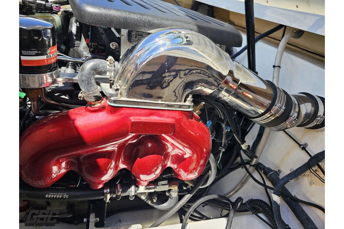 Engine compartment of a 2005 Formula 271 FASTech boat, featuring a red manifold and chrome intake.