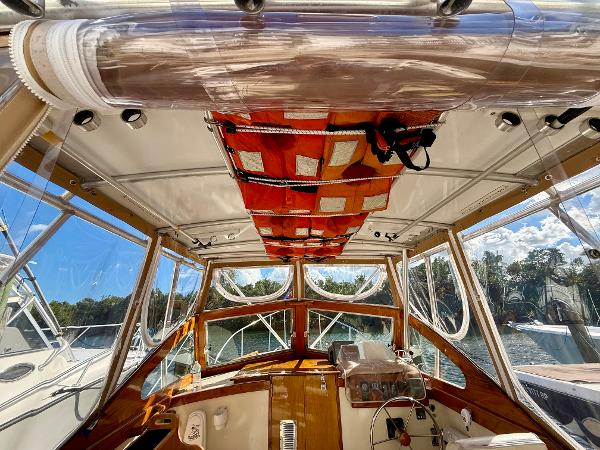 Interior view of a 1978 Dyer 29 Trunk Cabin boat with wooden accents and clear windows.