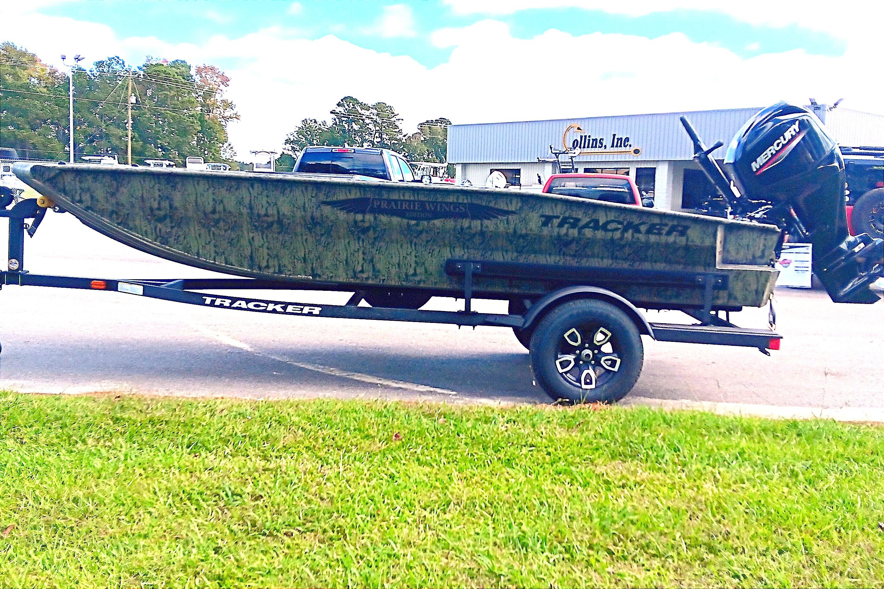 2026 Tracker Grizzly 1650 T Prairie Wings Edition boat on trailer, parked outdoors.