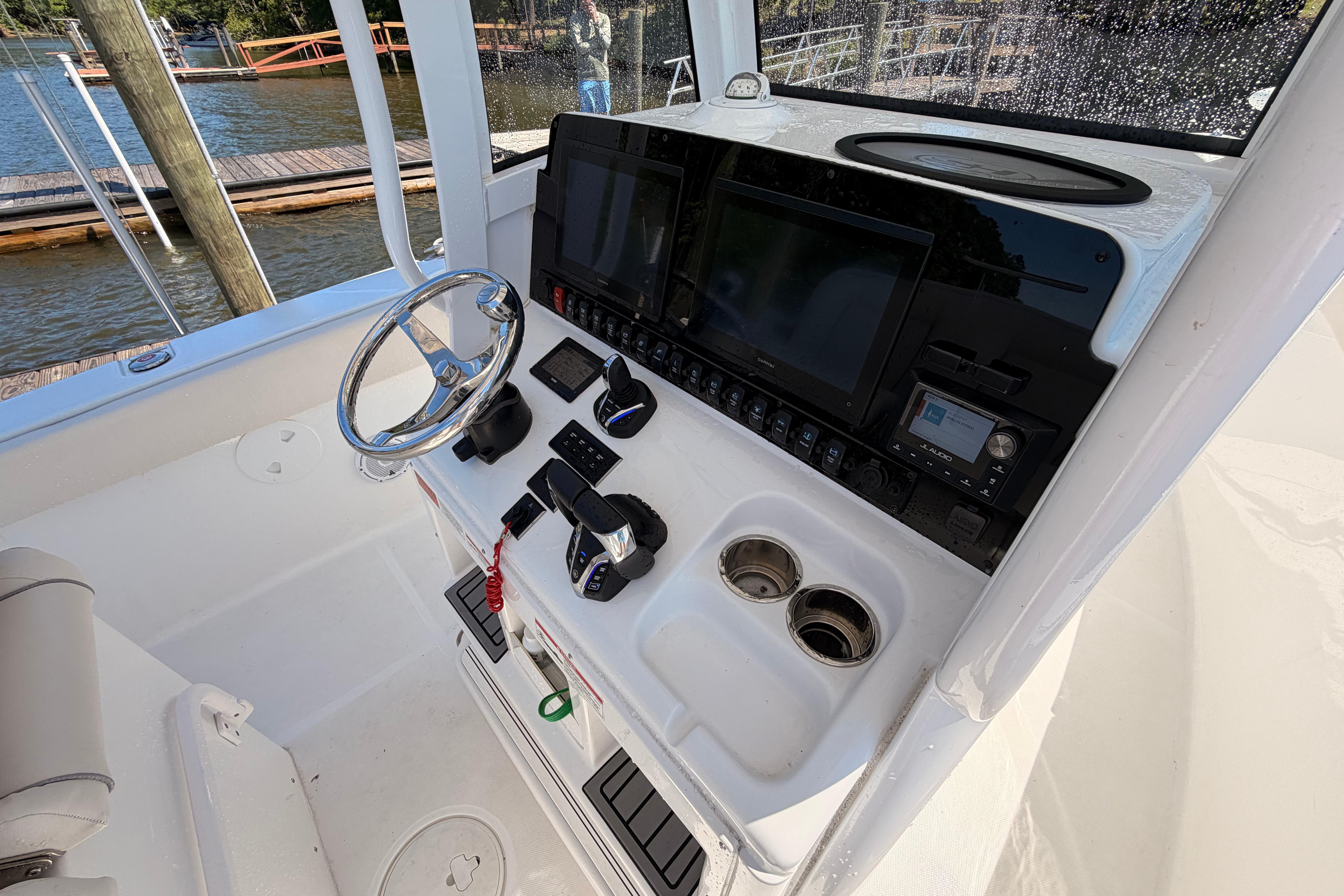 2024 Sea Hunt Gamefish 27 Coffin Box helm with advanced controls and navigation displays.