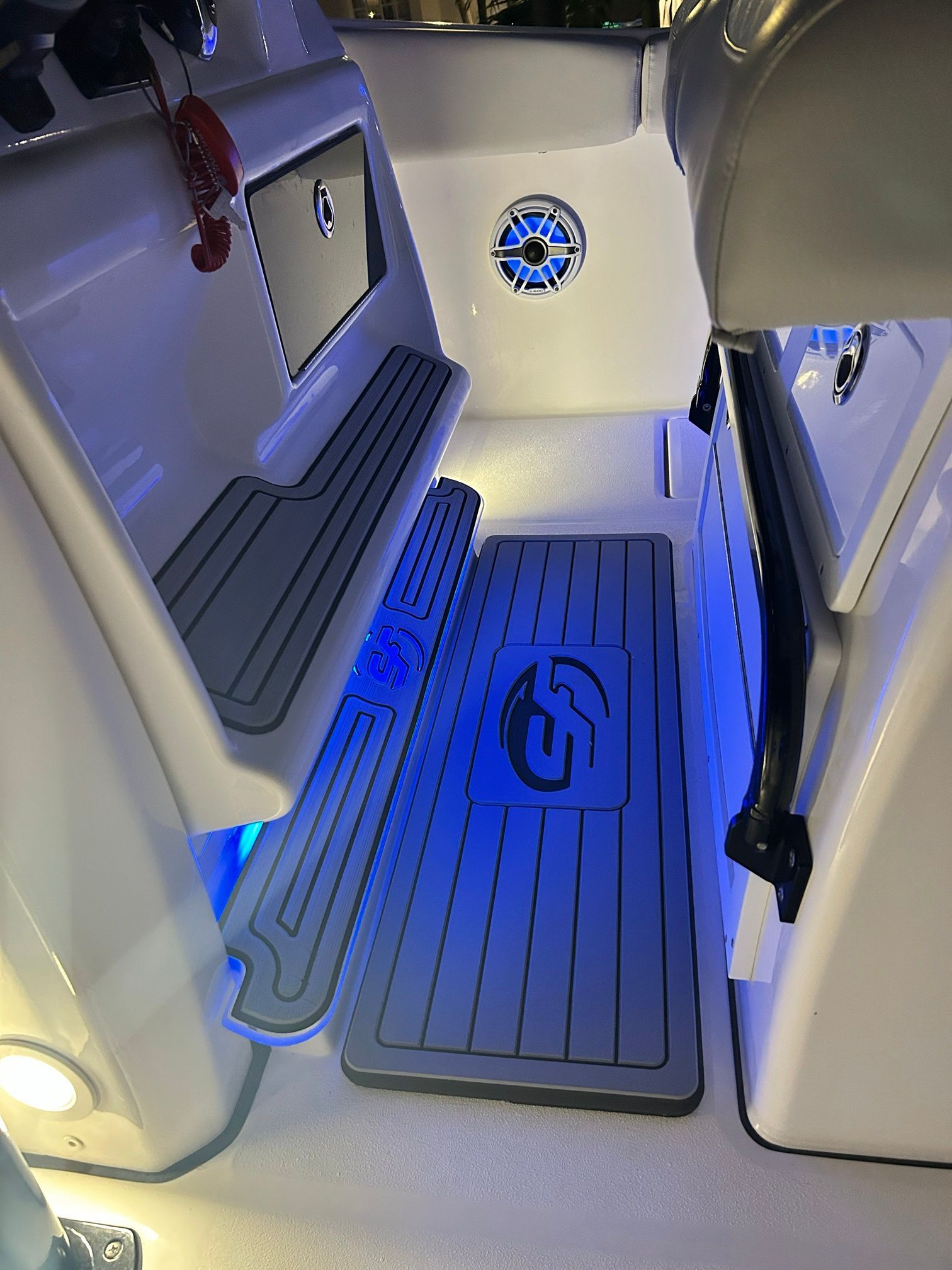 Interior of the Sea Fox 288 Commander with blue LED lighting and gray floor mats.